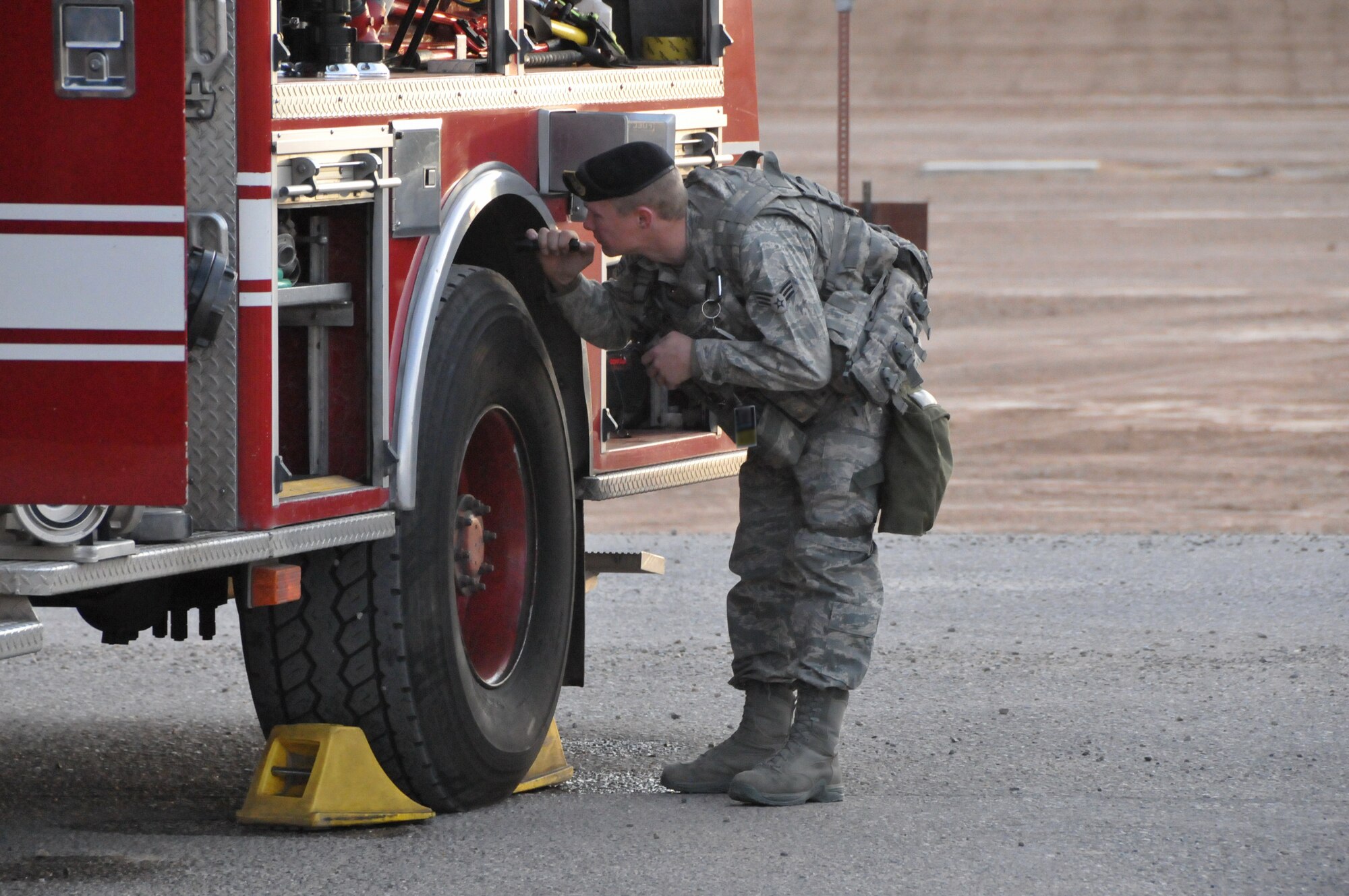 An Airman inspects a fire truck during a recent exercise at Kirtland Air Force Base. U.S. Air Force Photo by Ken Moore.
