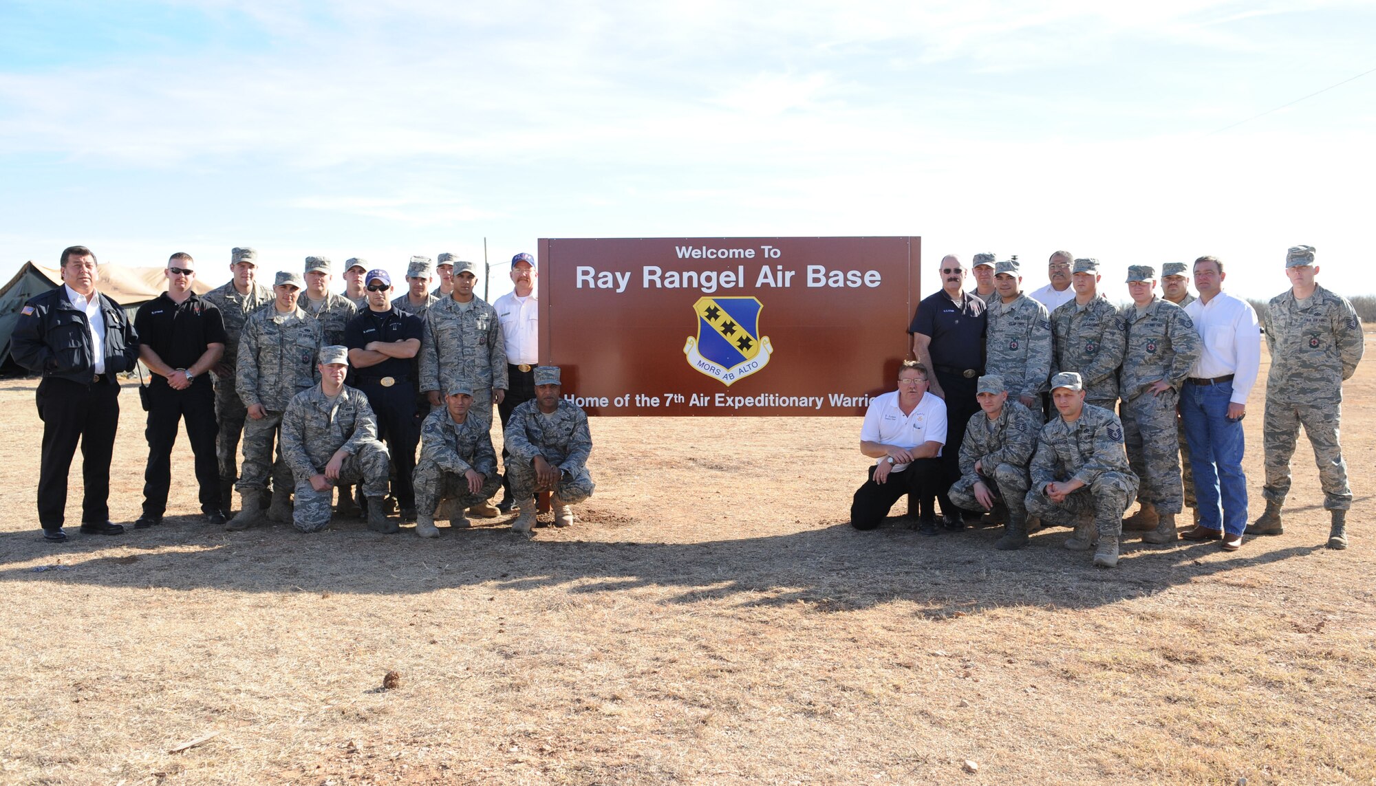 DYESS AIR FORCE BASE, Texas – Dyess firefighters pose Dec. 14 by a new sign honoring one of Dyess’ fallen Airmen at the cantonment area here. The cantonment area, used to host exercises and training sessions, has been renamed in honor of Staff Sgt. Ray Rangel, a 7th Civil Engineer firefighter who lost his life Feb. 13, 2005, at the age of 29, while on a rescue mission in Balad, Iraq. Sergeant Rangel was awarded the Bronze Star Medal Feb. 16, 2005, for his meritorious achievements while deployed. (U.S Air Force photo/ Airman 1st Class Shannon Hall)