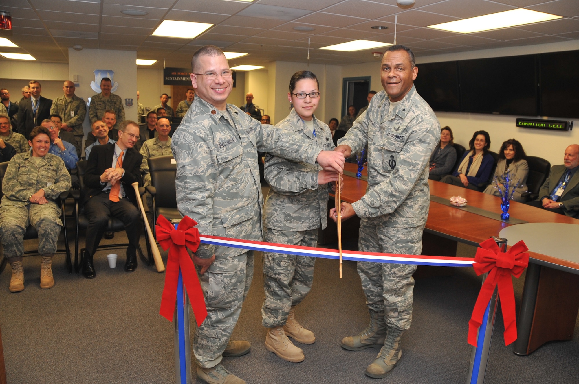 Maj. P.J. Pelkington, Sustainment and Integration Center director, Staff Sgt. Diana Trevizo, STIC, and Brig. Gen. Everett Thomas, AFNWC commander, cut the ribbon on the new STIC portion of Building 20202 at Kirtland Air Force Base. U.S. Air Force Photo by Elizabeth Martinez.