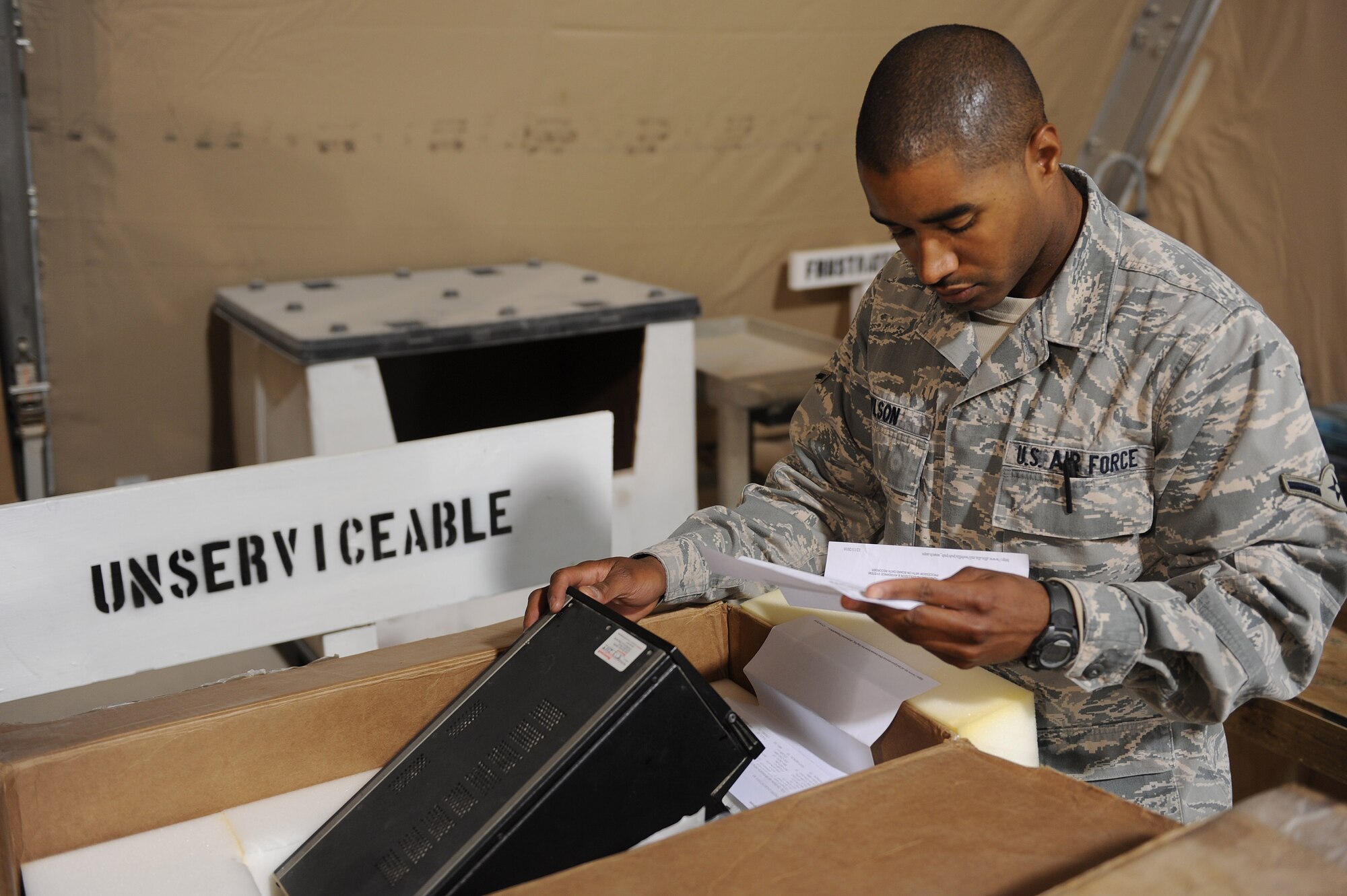 Airman Charlie Wilson checks the part number of an unserviceable aircraft part Dec. 16, 2010, at Kandahar Airfield, Afghanistan. The 451st Expeditionary Logistics Readiness Squadron Aircraft Parts Store supports 11 aircraft maintenance units with an inventory of more than 250,000 parts valued at $19 million. Airman Wilson, from Auburn, Ala., is a material management specialist assigned to the 451st ELRS. (U.S. Air Force photo by Tech. Sgt. Chad Chisholm/Released)