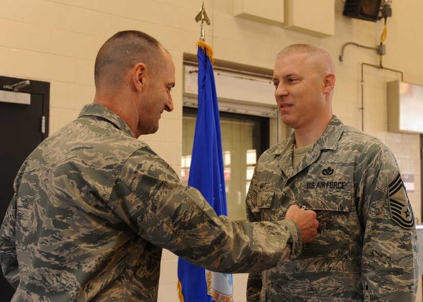 DYESS AIR FORCE BASE, Texas -- Col. David Been, 7th Bomb Wing commander, presents Chief Master Sgt. Christopher May, 7th Civil Engineer Squadron, with the Bronze Star Medal Dec. 16, during a ceremony at the fire department here. Chief May served as the 732nd Expeditionary Prime Beef Squadron superintendent at Balad Air Base, Iraq. While deployed he executed 200 logistic patrol movements, 90,000 convoy man-miles and $117 million in engineering projects supporting operating locations across Iraq. He also directed the completion of 48 horizontal and vertical troop labor projects valued at over $9 million and oversaw $50 million in joint forces essential projects at 24 locations, as well as the design and construction of over 60 schools, bridges and road projects for 7 million Iraqi citizens. (U.S. Air Force photo/Jenifer H. Calhoun)  