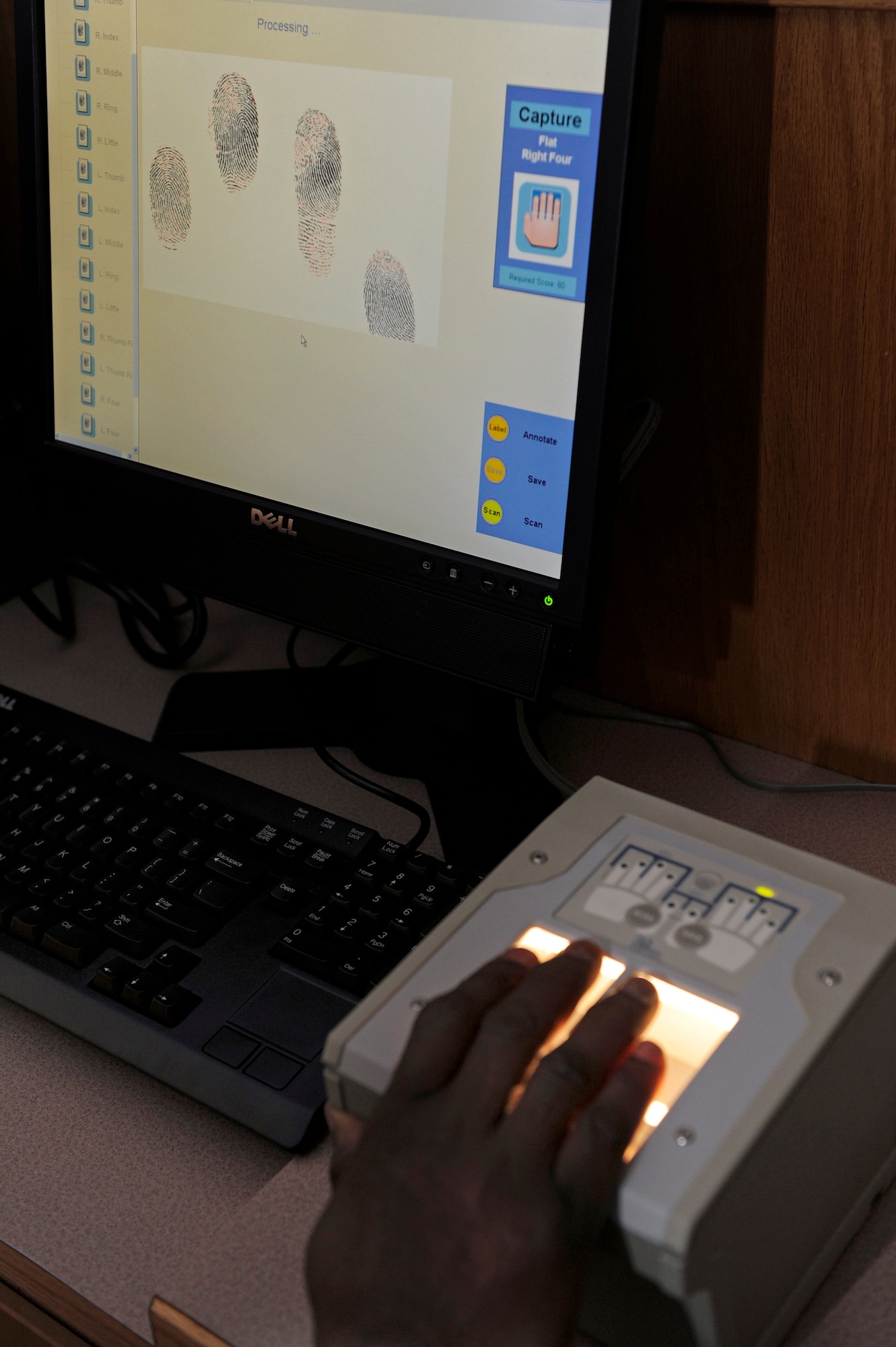 ELLSWORTH AIR FORCE BASE, S.D. -- Gary Parker, 28th Bomb Wing Information Protection Office personnel security program manager, demonstrates how their new digital fingerprinting system allows security professionals to electronically capture images, Dec. 10.  The system automatically scans for smudges or other problems, and will alert the user to rescan the fingerprint if there are errors. (U.S. Air Force photo/Staff Sgt. Marc I. Lane)