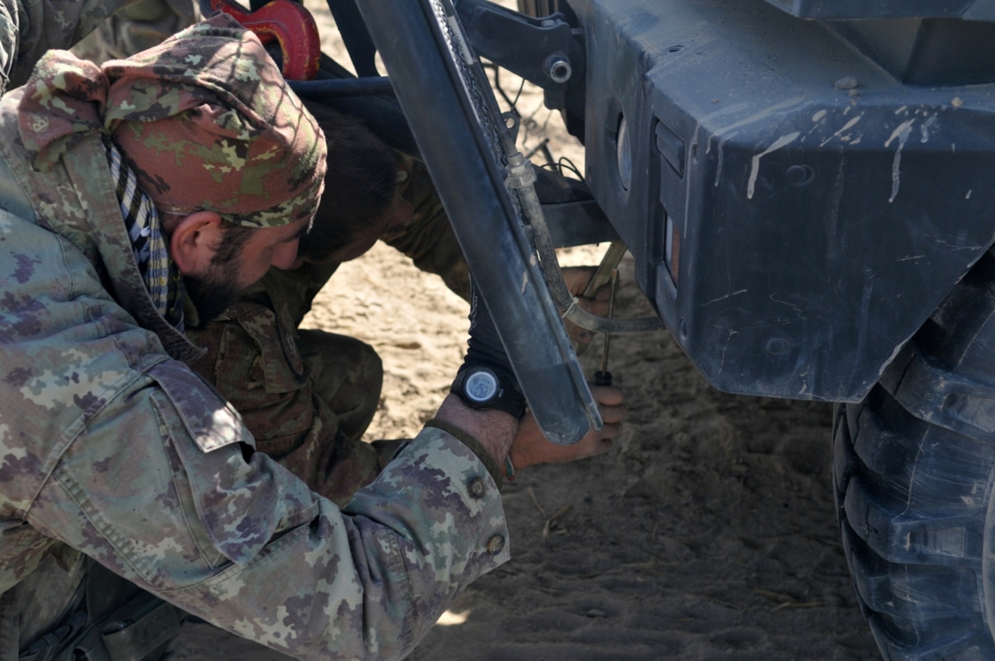 Two Italian soldiers from 6th Company remove a winch from their vehicle near Combat Outpost Victor, Badghis province, Afghanistan, Dec. 8. After one Italian vehicle became disabled, the Soldiers had to secure the area and fend of insurgent attacks. (U.S. Air Force photo/Tech. Sgt. Kevin Wallace)