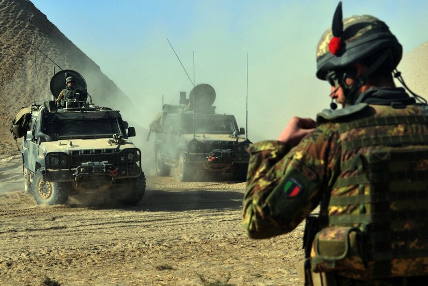 Italian Army Lt. Andrea Gilli, 6th Company platoon commander, utilizes his communication headset to order his soldiers into a defensive posture near Combat Outpost Victor, Badghis province, Afghanistan, Dec. 8. Just as the joint Italian-Afghan National Army convoy passed the bubble’s perimeter, they struck an improvised explosive device. Soon after that, they defeated waves of insurgent attacks while troops up on the mountaintop at COP Victor provided suppressive fire and over watch. (U.S. Air Force photo/Tech. Sgt. Kevin Wallace)
