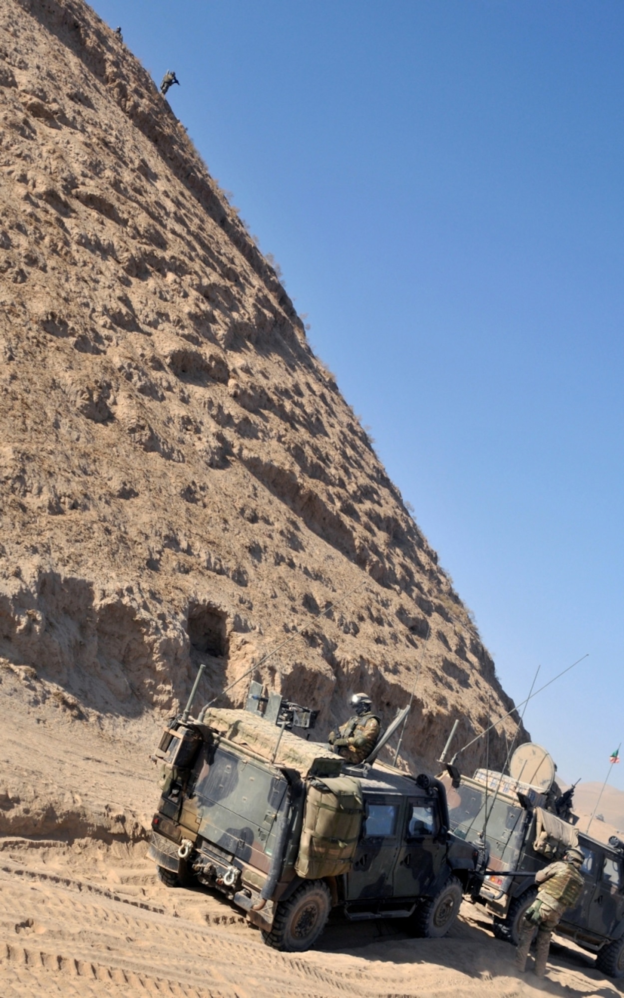 Afghan National Army soldiers take an over-watch position and help protect an Italian convoy near Combat Outpost Victor, Badghis province, Afghanistan, Dec. 8. After one Italian vehicle became disabled, the Soldiers had to secure the area and fend of insurgent attacks. (U.S. Air Force photo/Tech. Sgt. Kevin Wallace)