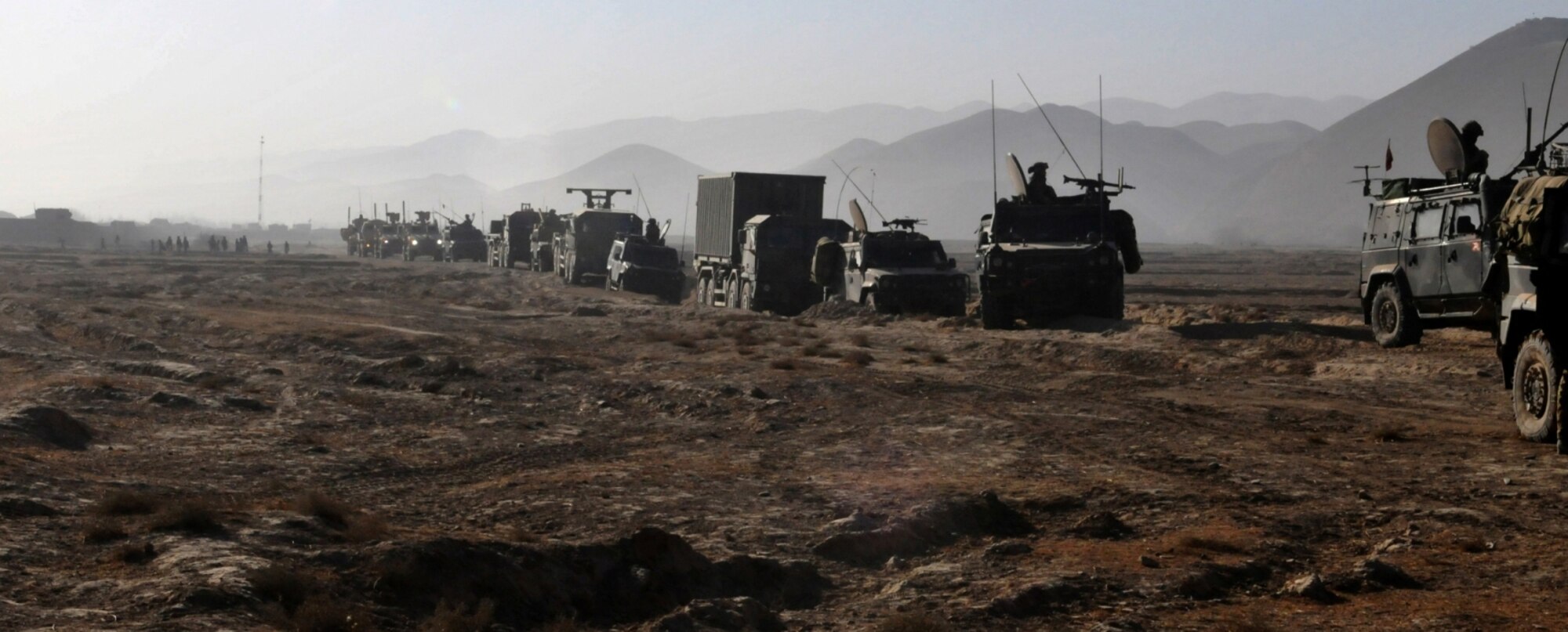 A convoy of Italian, U.S. and Afghan National Army vehicles travels from Forward Operating Base Prius, Badghis province, Afghanistan, to Combat Outpost Victor, the northern-most COP on the perimeter of the security bubble protecting the Bala Murghab valley. The convoy resupplied the COP Dec. 8. (U.S. Air Force photo/Tech. Sgt. Kevin Wallace)