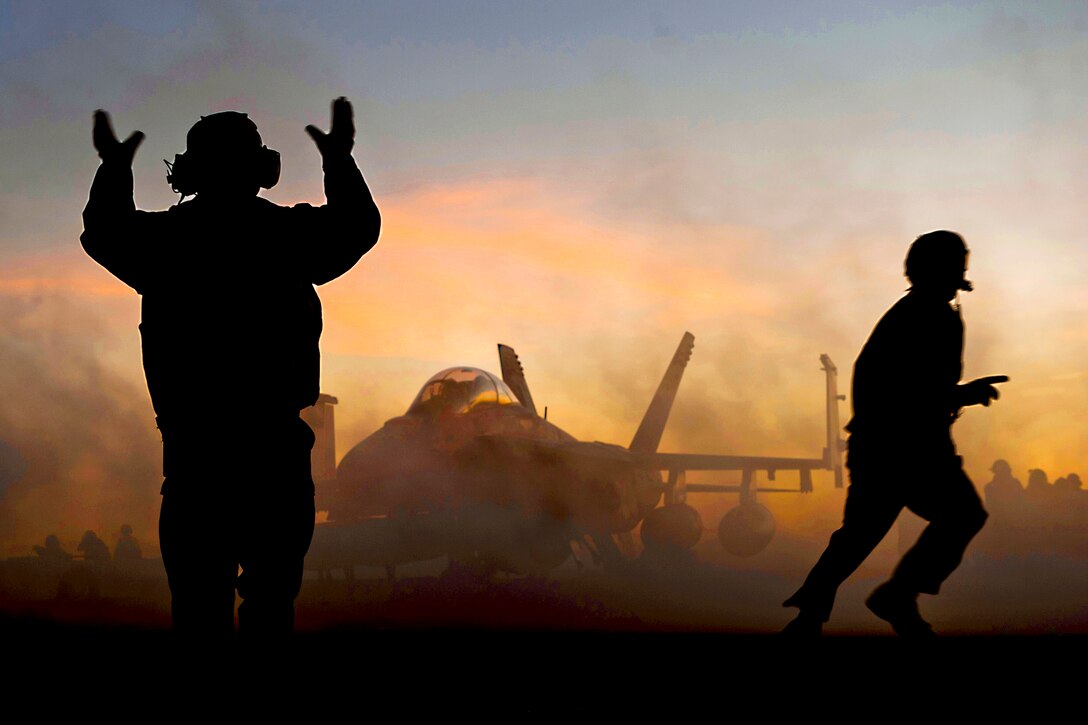 An aircraft director guides an F/A-18F Super Hornet after it made an arrested landing on the flight deck of the aircraft carrier USS Carl Vinson in the Pacific Ocean, Dec. 11, 2010. The Carl Vinson and Carrier Air Wing 17 are on a three-week training exercise before a deployment to the western Pacific Ocean. The Hornet is a part of Strike Fighter Squadron 22.