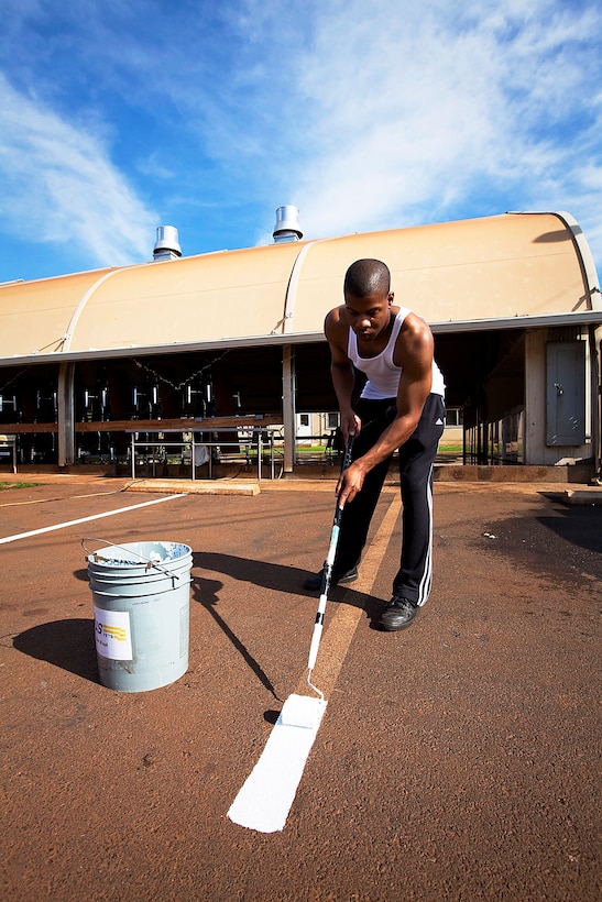 Cpl. James Owens, a radio operator with Headquarters Company, 1st Battalion, 12th Marine Regiment, paints new lines in the parking lot while volunteering at the Waianae Civic Center in Waianae, Hawaii, Dec. 17, 2010. Only hours before departing on winter holiday leave, 20 Headquarters Co. Marines volunteered their time to clean up the grounds of the center, which houses homeless veterans and their families. Opened in 2007 by Hawaii Gov. Linda Lingle, the center is operated by the United States Veterans Initiative, the nation’s largest non-profit provider of services to veterans facing challenges in their transition to civilian life. It provides housing and transitional programs for approximately 275 people.