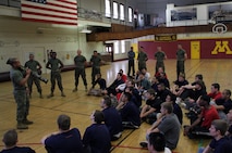 Marine Corps Substation Roseville Recruiter Sgt. Van Tulmau, 29, gives a class on an anti-tank weapon, also known as the AT4, at the University of Minnesota Armory Dec. 18. More than 30 people, including a few Marines who recently completed boot camp, attended the poolee function. Service members have been training at the armory since it was built in 1896.