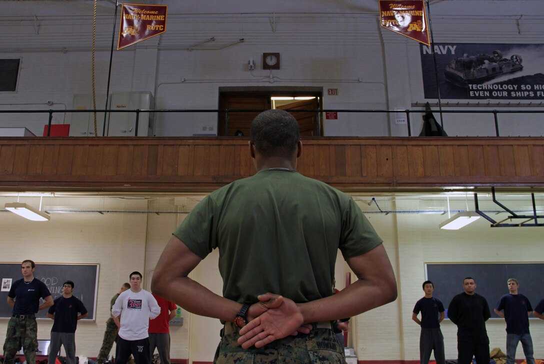Pvt. Cecil Howard, 19, from New Brighton, Minn., demonstrates how to properly execute drill movements to more than 30 Marine applicants during a Recruiting Substation Roseville poolee function at the University of Minnesota Armory Dec. 18. Howard, a Mounds View High School graduate, completed boot camp Nov. 24.
