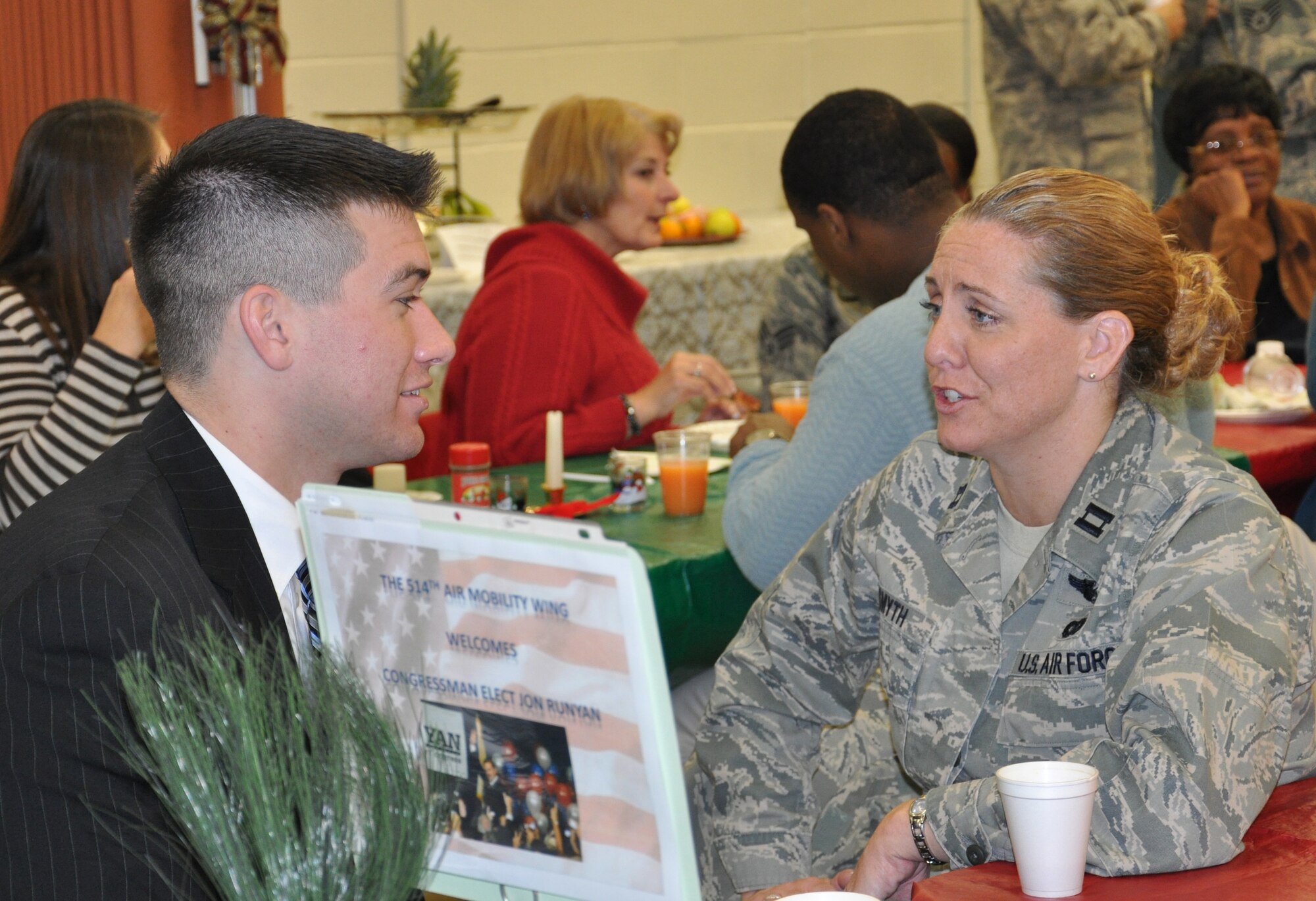 JOINT BASE MCGUIRE-DIX-LAKEHURST, N.J. -- Brandon Umba, Field Director for Congressman-elect Jon Runyan, talks with Capt. Kelly Smyth, public affairs officer, 514th Air Mobility Wing, during the Reserve wing's 22nd annual holiday breakfast, held Dec. 16, here. (U.S. Air Force photo/Master Sgt. Donna T. Jeffries) 