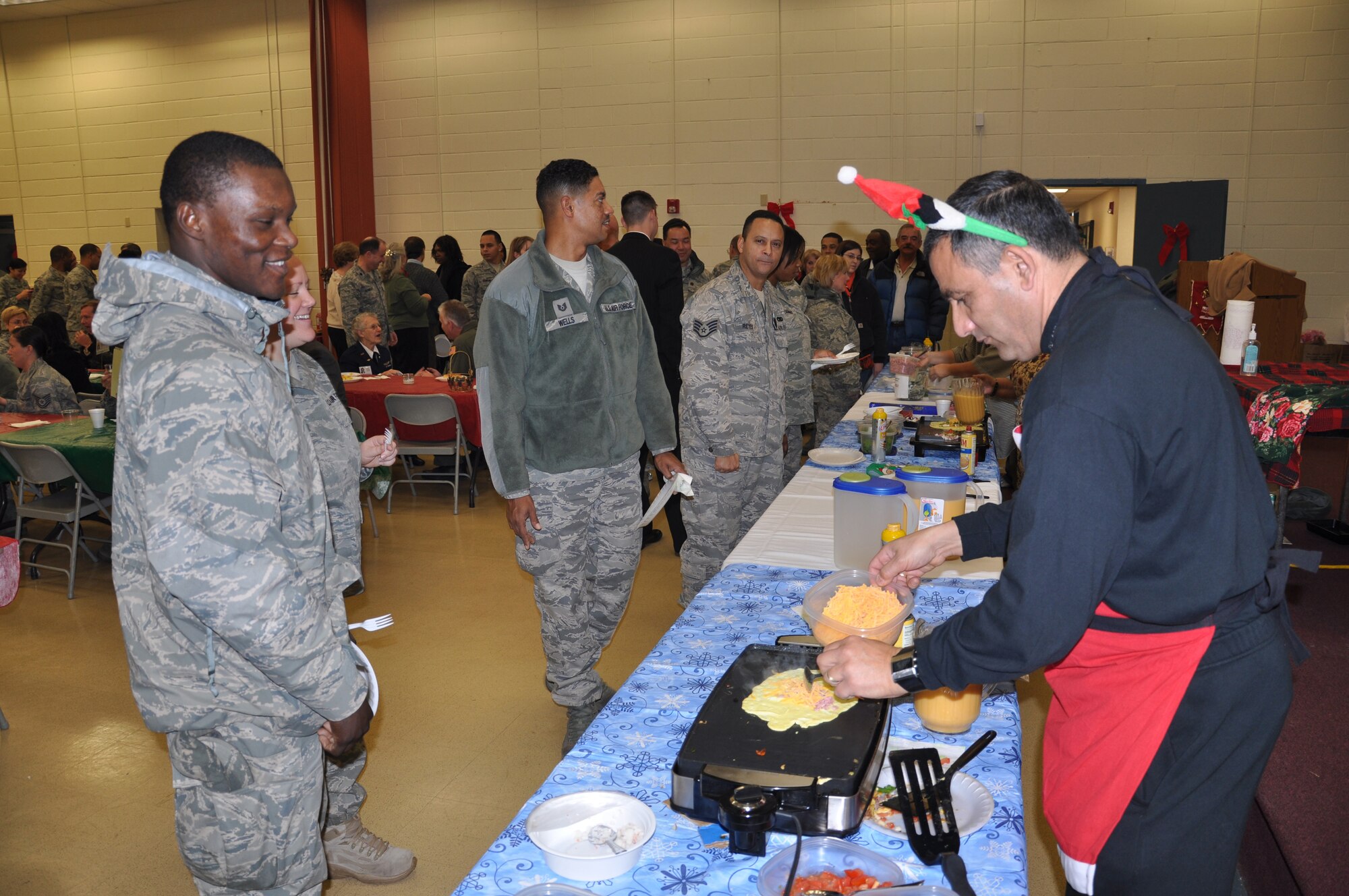 JOINT BASE MCGUIRE-DIX-LAKEHURST, N.J. -- 514th Air Mobility Wing members and guests enjoy a breakfast of made-to-order omelets and a variety of other items at the Reserve wing's 22nd annual holiday breakfast held Dec. 16, here. (U.S. Air Force photo/Master Sgt. Travon W. Dennis)