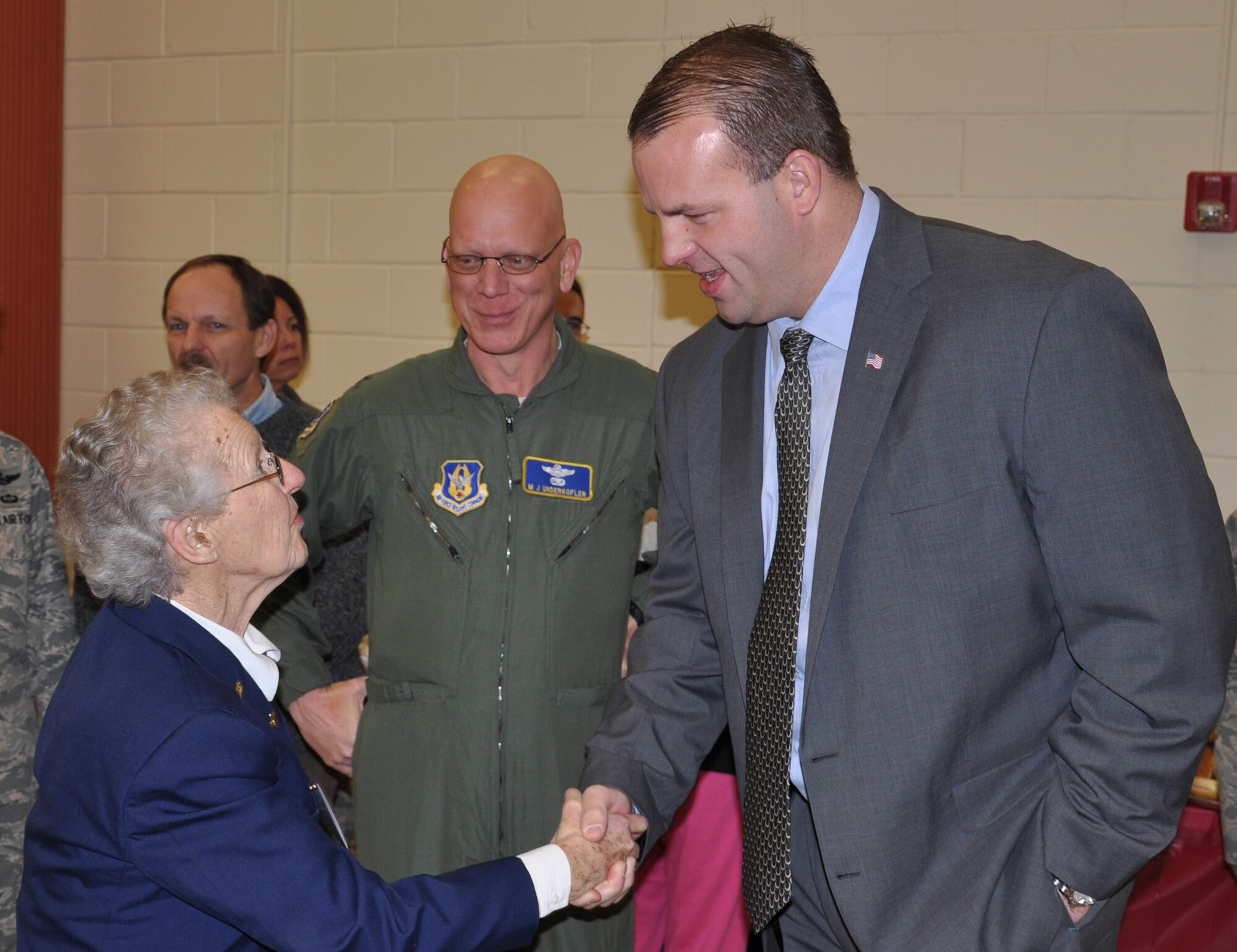 JOINT BASE MCGUIRE-DIX-LAKEHURST, N.J.  --  Col. Michael Underkofler, vice wing commander, 514th Air Mobility Wing looks on as Congressman-elect Jon Runyan greets World War II veteran and Women Airforce Service Pilot, Mrs. Lillian Yonally at the Reserve wing's 22nd annual holiday breakfast held Dec. 16, here. (U.S. Air Force photo/Master Sgt. Travon W. Dennis)