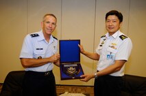 Maj. Gen. Ng Chee Meng (right), Chief of the Republic of Singapore Air Force, presents Maj. Gen. Brooks Bash, Pacific Air Forces vice commander, with a commemorative plaque during the exercise Cope Tiger 2011 opening ceremony at Paya Lebar Air Base, Singapore, on Dec. 13, 2010.  Cope Tiger is an annual, multilateral aerial large force exercise conducted in the Asia-Pacific region. (Courtesy photo) 
