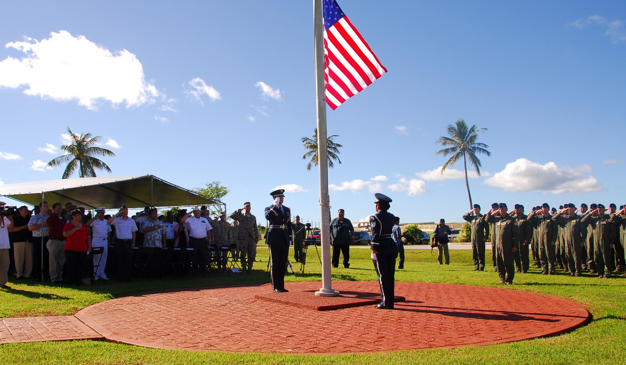 Team Andersen Airmen and audience members render a salute as Taps is played, in honor of the lives of 33 men and women that were lost during Operation Linebacker ll, at a memorial ceremony on Andersen Air Force Base, Guam, Dec. 17.  The ceremony commemorates the 38th anniversary of the campaign that led to the end of the Vietnam War.  (U.S. Air Force photo/Staff Sgt. Jamie Powell)