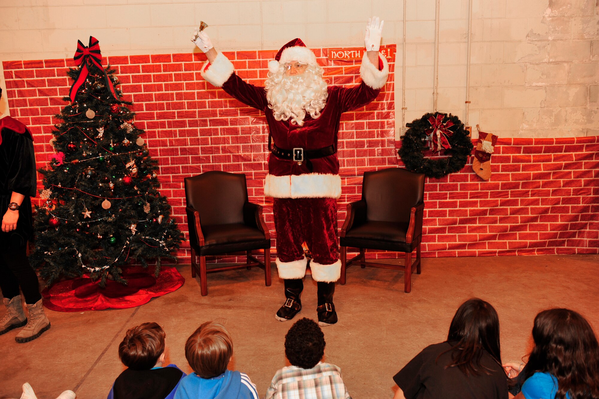 Santa Claus greets all of the children of personnel with the 33rd and the 31st Rescue Squadron at Kadena Air Base, Dec. 17. Santa wasn't the only attraction at this year's celebration. There were also games, bouncers, cake decorating and other events available to keep the kids entertained. (U.S. Air Force photo/Staff Sgt. Lakisha Croley)