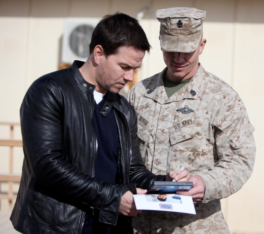 Actor Mark Wahlberg signs an autograph for a sailor at Camp Leatherneck, Afghanistan, Dec. 19. Wahlberg shook hands and took pictures with service members while thanking them for their service. More than 100 anxious fans waited in line to meet Wahlberg.