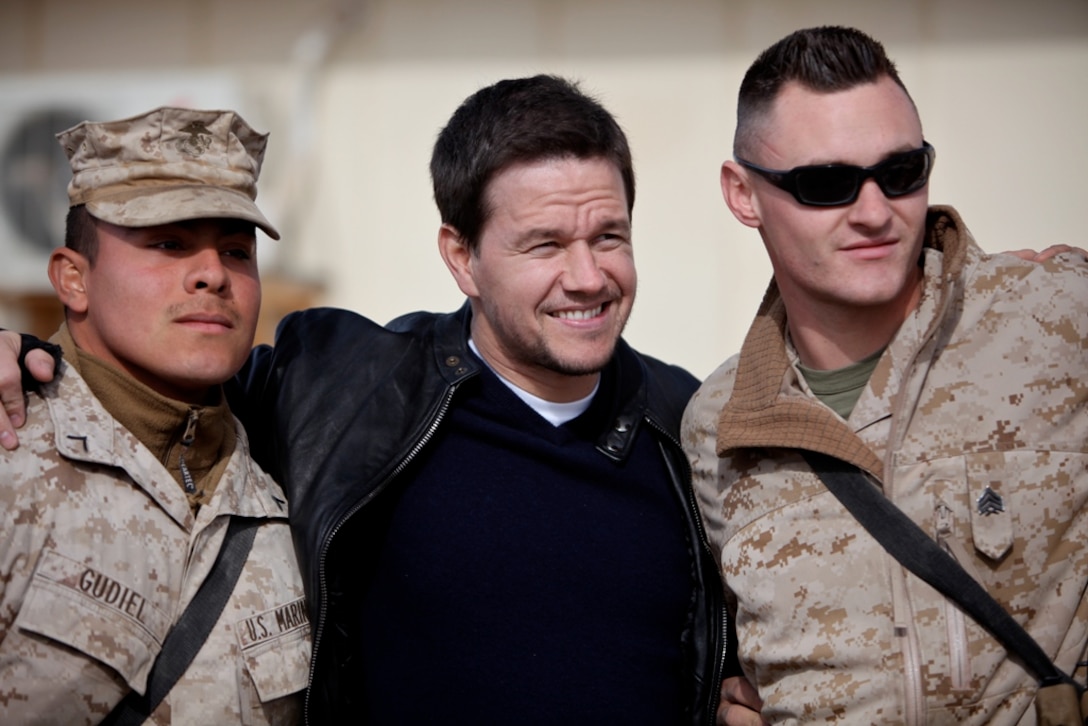 Marines with 1st Marine Logistics Group (Forward) take a photo with actor Mark Wahlberg during Wahlberg's visit of 1st Marine Logistics Group (Forward) at Camp Leatherneck, Afghanistan, Dec. 19. Wahlberg shook hands and took pictures with service members while thanking them for their service. More than 100 anxious fans waited in line to meet Wahlberg.