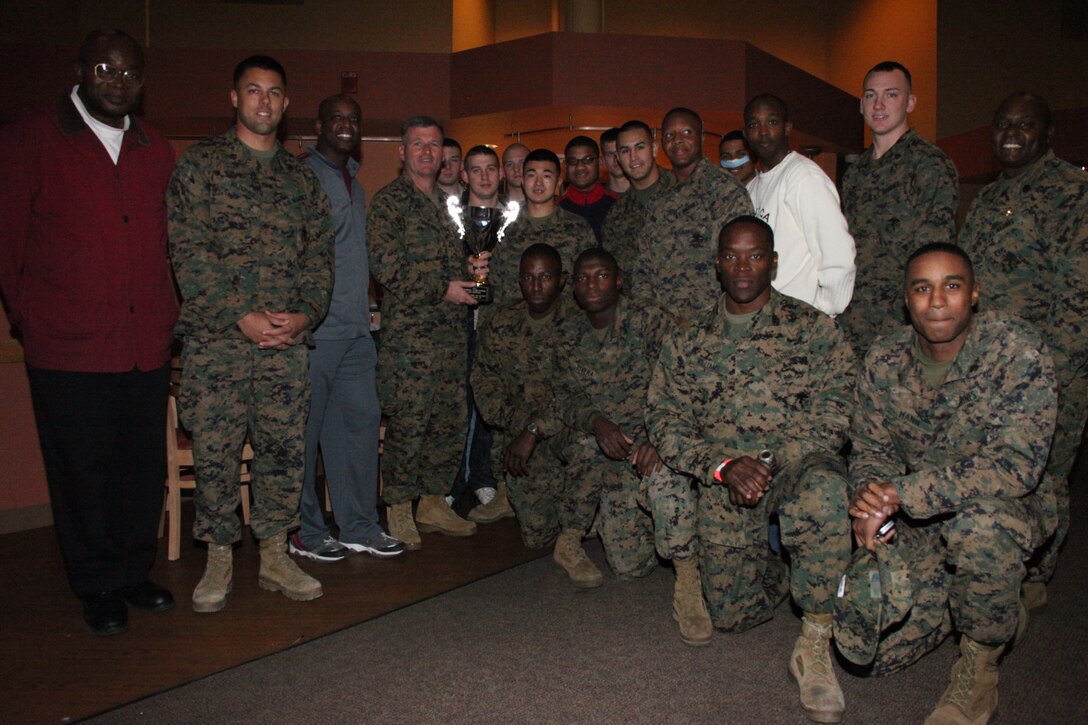 Col. Philip J. Zimmerman, center, commanding officer of Marine Corps Air Station Cherry Point, presents the air station’s football team, the Cherry Point Eagles, with the Regional Intramural Football Championship trophy at Cunningham’s Dec. 20, 2010. The last time the Eagles won the championship was in 2006.