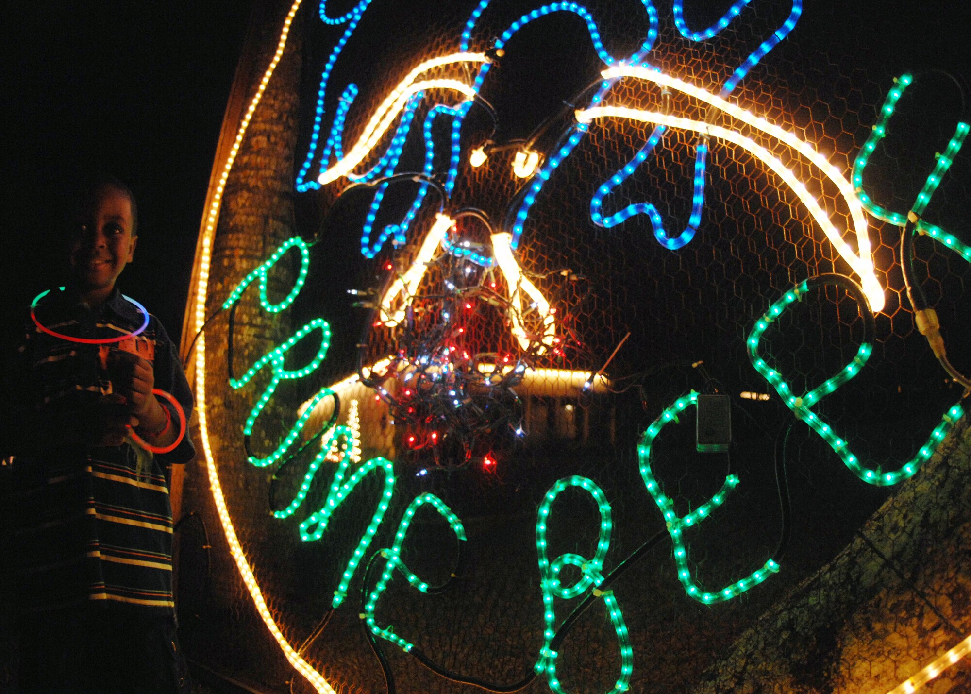 A child enjoys the decorations and festivities during Rota Walk Dec. 18, an annual pilgrimage down Rota Drive, and one of Team Andersen’s most beloved traditions. More than 50 houses were adorned with lights and decorations that represented each commander’s respective unit.  The event hosted a number attractions including a live Nativity scene hosted by the Andersen Chapel, gospel and elementary school choirs singing carols, and a performance by the Guam High School and Air Force Alaska Brass Band at the 36th Wing Commander, Brig. Gen. John Doucette's house. (U.S. Air Force photo/ Airman 1st Class Anthony Jennings)