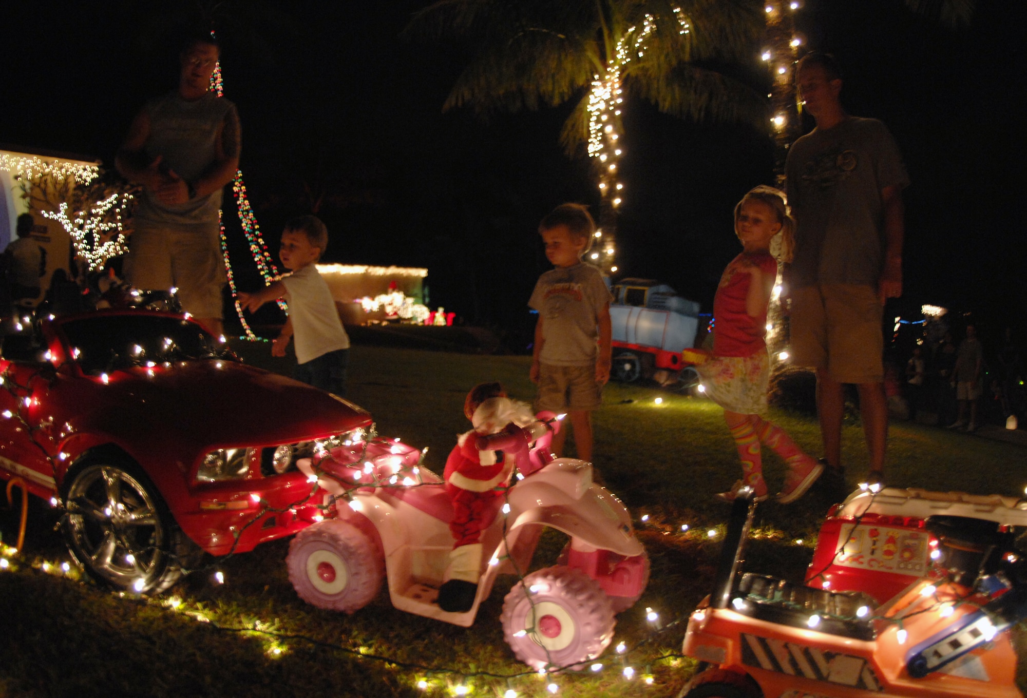 Children and adults alike were treated to a holiday wonderland in the tropics during Rota Walk Dec. 18, on Rota Drive. The street is occupied by commander’s on base, each decorating their house to represent their respective unit.  The event hosted a number attractions including a live Nativity scene hosted by the Andersen Chapel, gospel and elementary school choirs singing carols, and a performance by the Guam High School and Air Force Alaska Brass Band at the 36th Wing Commander, Brig. Gen. John Doucette's house. (U.S. Air Force photo/ Airman 1st Class Anthony Jennings)