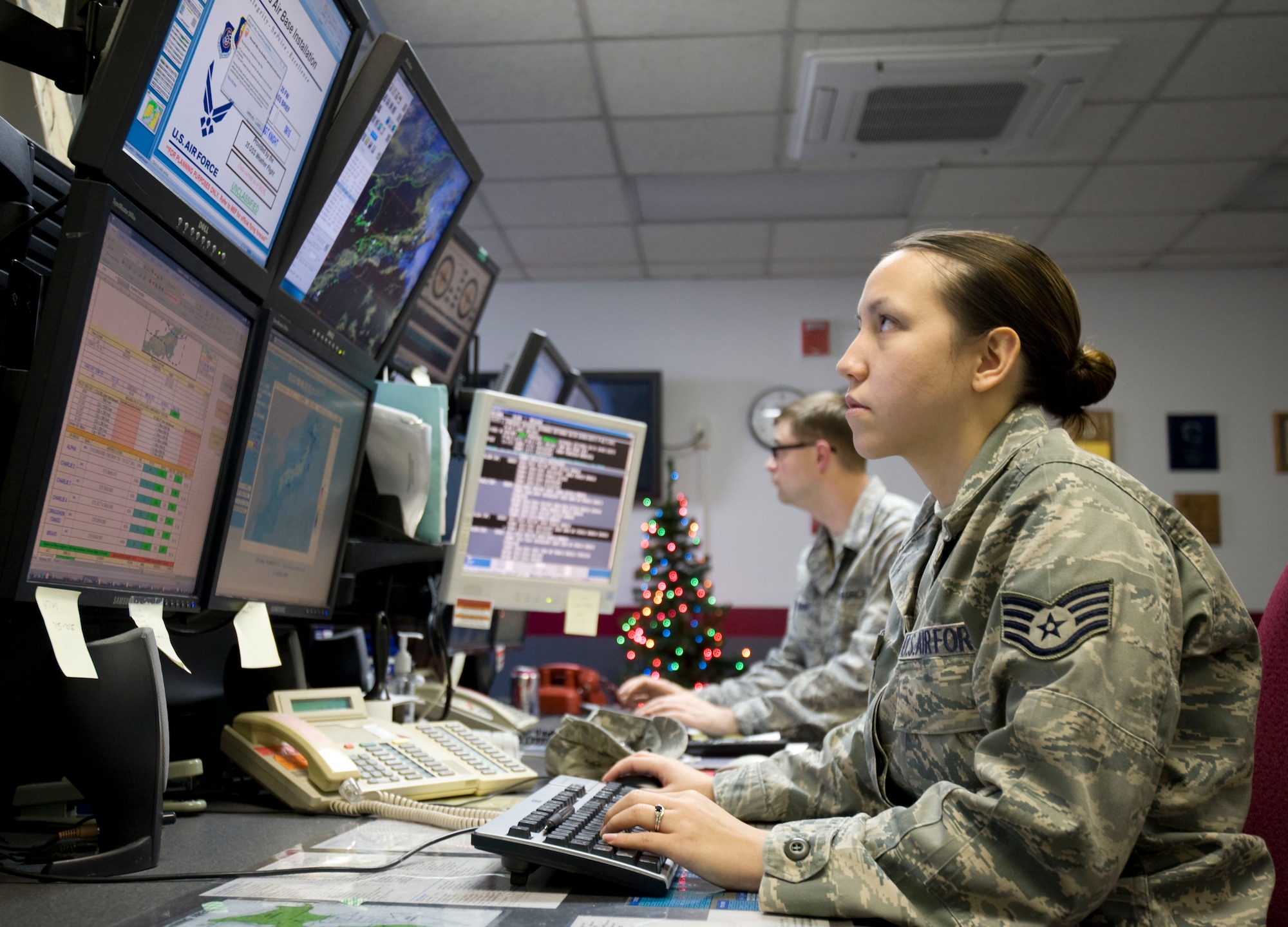 U.S. Air Force Staff Sgt. Tina Kay, 35th Operations Support Squadron Weather Flight weather forecaster, and Tech. Sgt. Stoney Bair, 35th OSSWF NCOIC mission weather element, track and analyze weather data at Misawa Air Base, Japan, Dec. 20, 2010. The flight uses computer-based systems, including radar, satellite, model outputs and real-time observation, The 35th OSSWF’s primary job is to support the flying mission by providing pilots with weather forecasts. The 35th OSSWF also provides alternate landing locations for aircraft in case a pilot is unable to reach a runway due to weather conditions such as sea fog. (U.S. Air Force photo by Airman James B. Bauer/Released)
