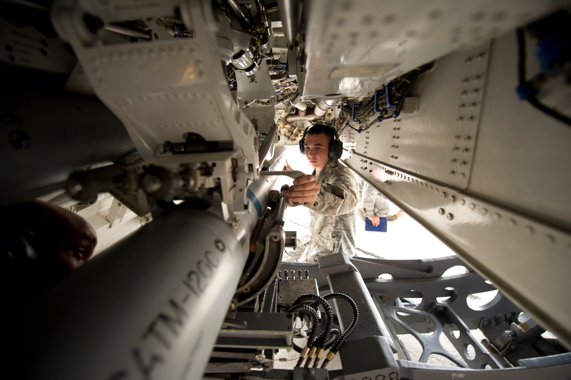 HOLLOMAN AIR FORCE BASE, N.M. - Airman Christopher Murphey, 49th Aircraft Maintenance Squadron, connects a buffer to a Guided Bomb Unit-32 Joint Direct Attack Munitions being loaded onto an aircraft during a load crew competition Dec. 17, 2010. Airman Murphey is competing in the December load crew competition where teams compete for the title of best load crew. (U.S. Air Force photo by Airman 1st Class Joshua Turner/Released)
