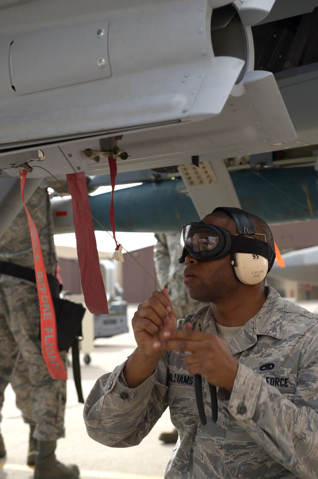 HOLLOMAN AIR FORCE BASE, N.M. - Airman 1st Class Samuel Williams, 849th Aircraft Maintenance Squadron, prepares the wiring release lanyard during a load crew competition Dec. 17, 2010. Airman Williams is competing in the quarterly load crew competition which tests crews in areas such as safety, accuracy and adherence to technical orders. (U.S. Air Force photo by Airman 1st Class Joshua Turner/Released)