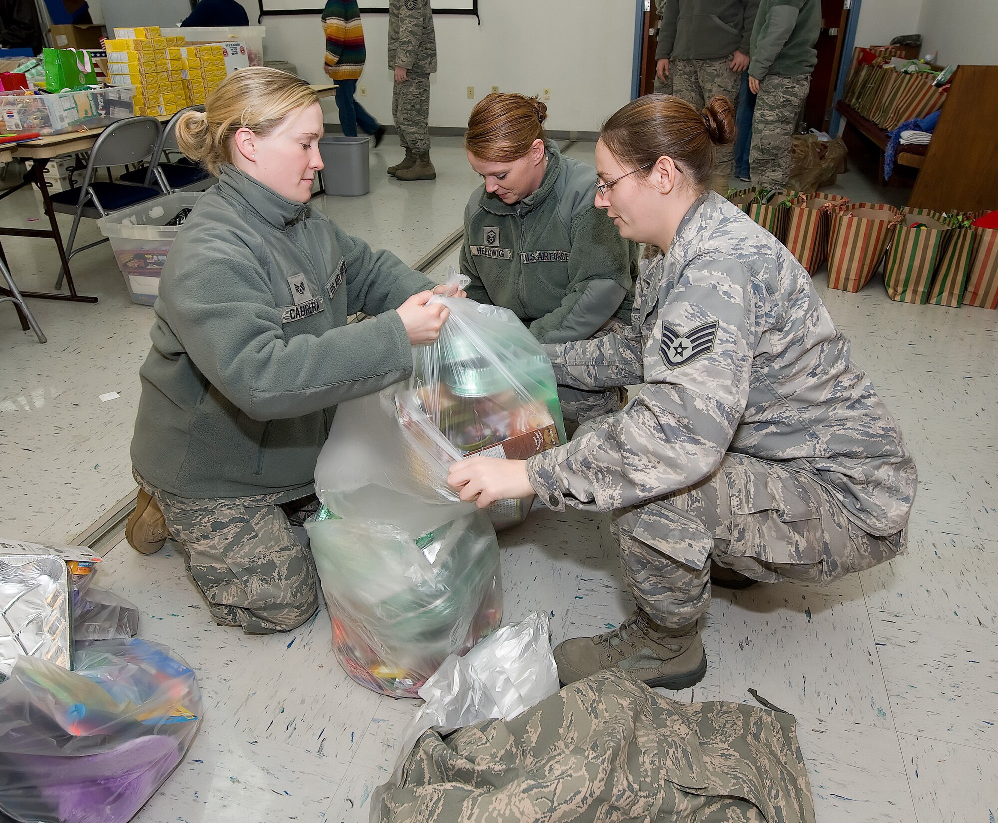 Members from Dover Air Force Base, Del., package items for stockings during the "Deployed Spouse Stocking Event" Dec. 15, 2010. The event was sponsored by the United Service Organization and the Airman & Family Readiness Center and its goal was to make stockings for families of deployed servicemembers. The event served more than 120 families. (U.S. Air Force photo by Jason Minto/Released)