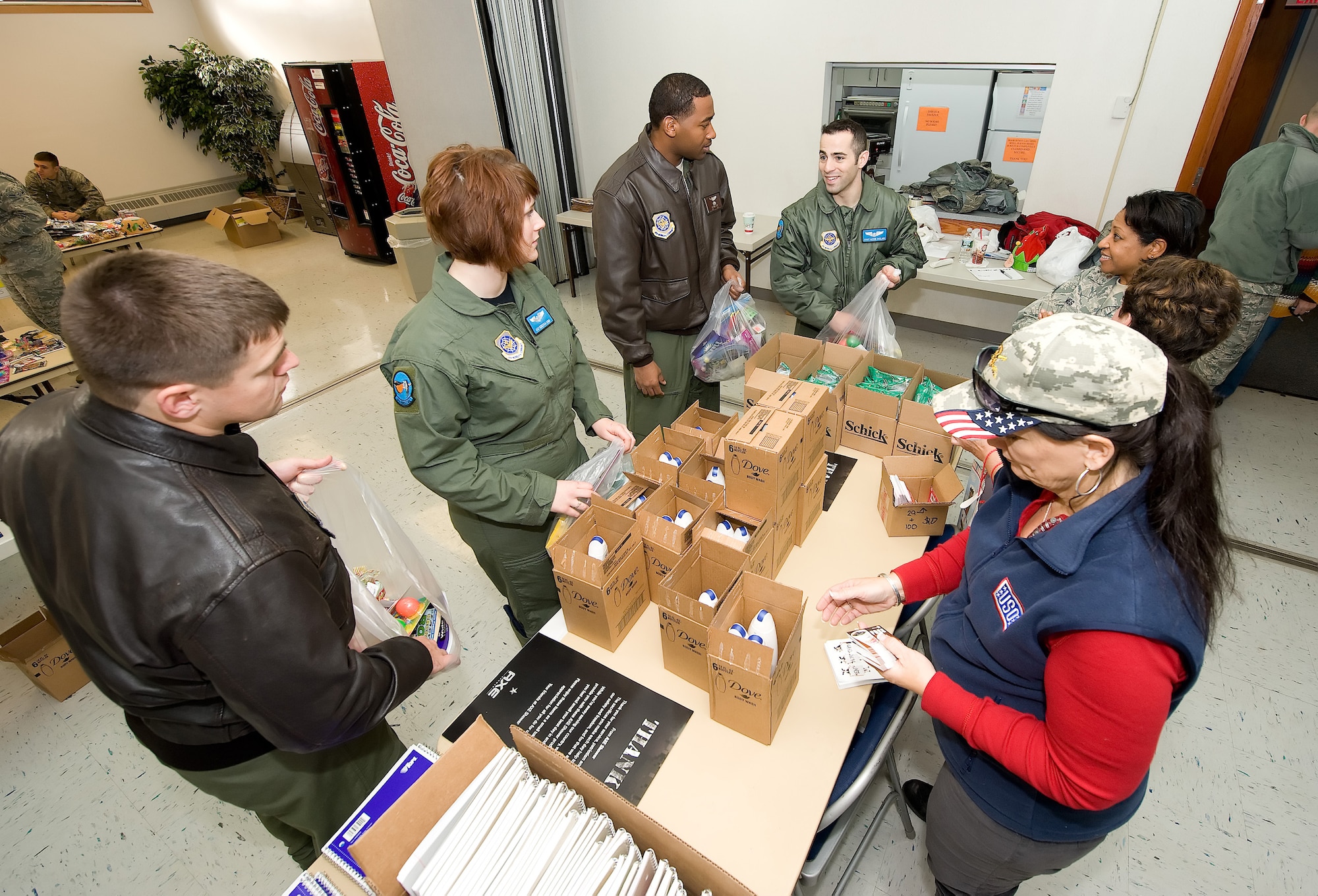 Members from Dover Air Force Base, Del., gather stocking kits together during the "Deployed Spouse Stocking Event" Dec. 15, 2010. The event was sponsored by the United Service Organization and the Airman & Family Readiness Center and its goal was to make stockings for families of deployed servicemembers. The event served more than 120 families. (U.S. Air Force photo by Jason Minto/Released)