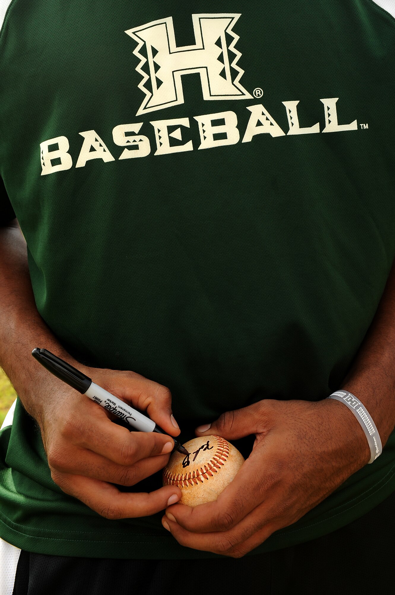 University of Hawaii and Hawaii Pacific University baseball coaches and players sign autographs after the Friends of Hickam baseball clinic Dec. 18. Hickam and Pearl Harbor children were taught baseball fundamentals by University of Hawaii and Hawaii Pacific University coaches and players duringthe event. The baseball clinic is the first of an annually planned event for the Friends of Hickam. (U.S. Air Force photo/Staff Sgt. Mike Meares)