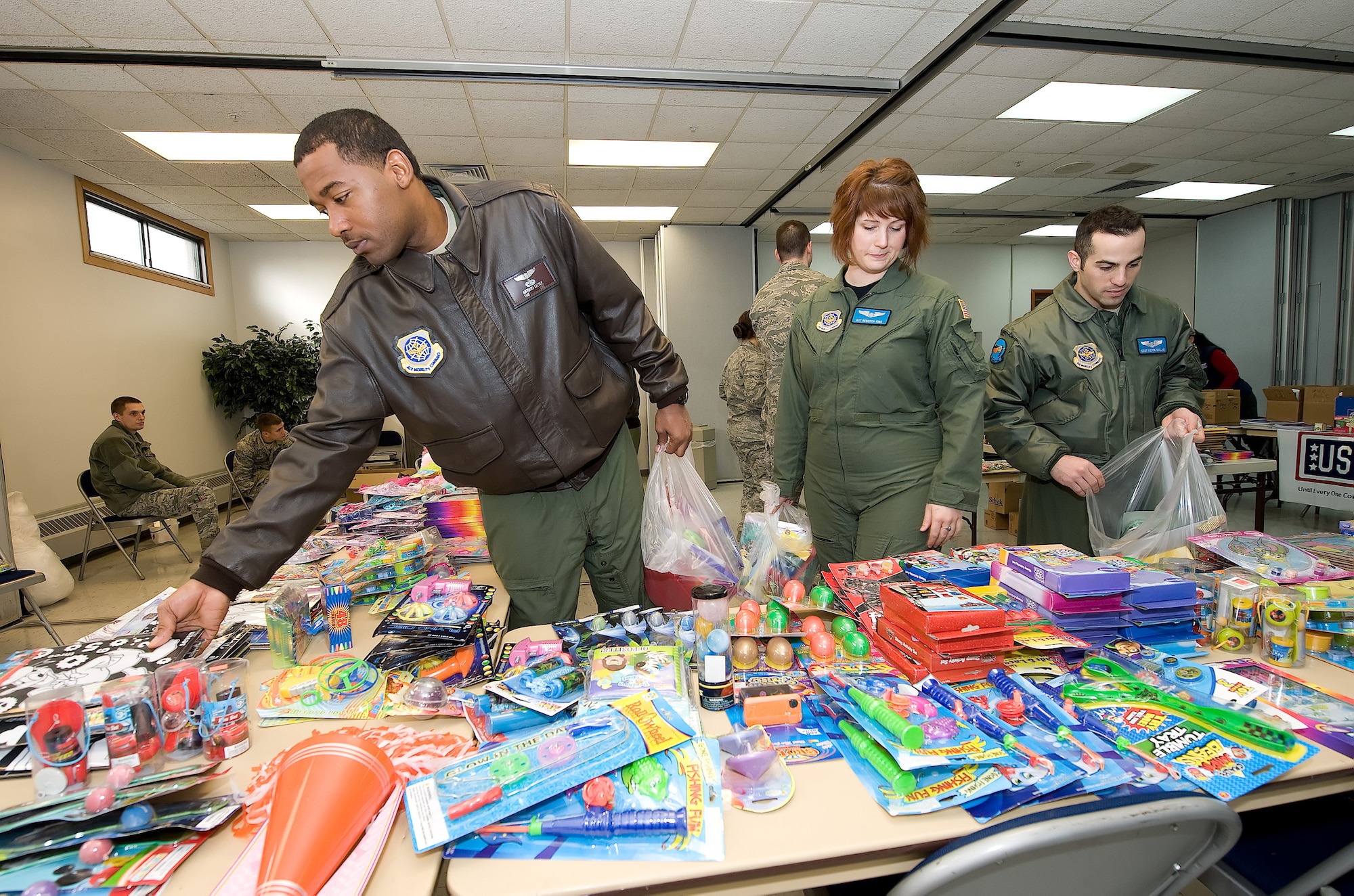 Members from Dover Air Force Base, Del., choose items for stockings during the "Deployed Spouse Stocking Event" Dec. 15, 2010. The event was sponsored by the United Service Organization and the Airman & Family Readiness Center and its goal was to make stockings for families of deployed servicemembers. The event served more than 120 families. (U.S. Air Force photo by Jason Minto/Released)