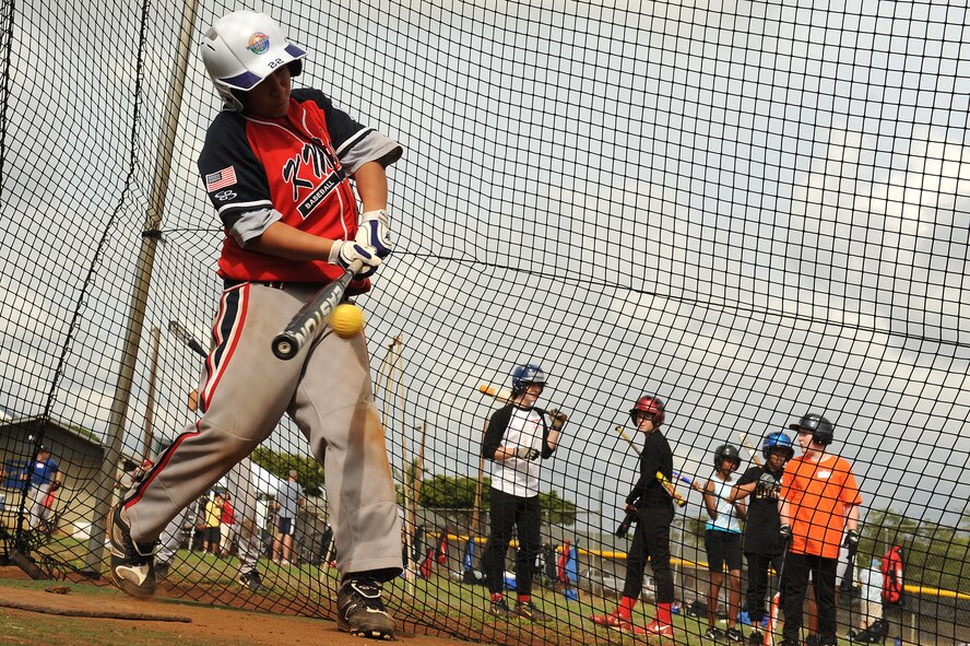 Jake Gonzalez, 13, males contact  in the batting cage during the Friends of Hickam baseball clinic Dec. 18. Hickam and Pearl Harbor children were taught baseball fundamentals by University of Hawaii and Hawaii Pacific University coaches and players duringthe event. The baseball clinic is the first of an annually planned event for the Friends of Hickam. (U.S. Air Force photo/Staff Sgt. Mike Meares)