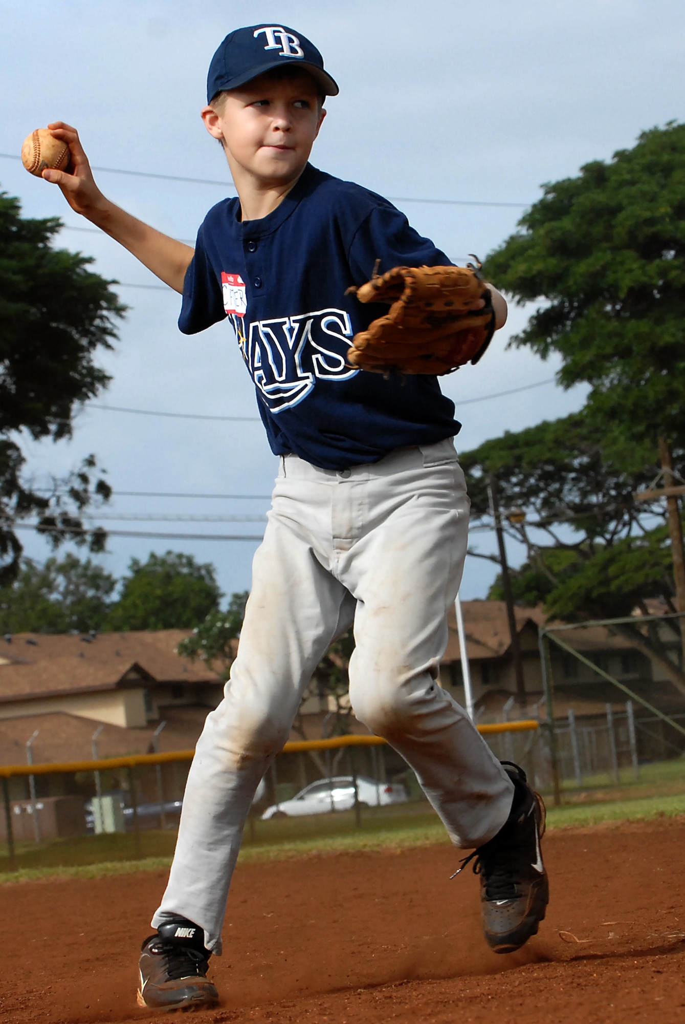 Carter "Firecracker" Golovach, 11, takes ground balls and works on turning a double play during the infield portion of the Friends of Hickam baseball clinic. Dec. 18. Hickam and Pearl Harbor children were taught baseball fundamentals by University of Hawaii and Hawaii Pacific University coaches and players duringthe event. The baseball clinic is the first of an annually planned event for the Friends of Hickam. (U.S. Air Force photo/Staff Sgt. Mike Meares)