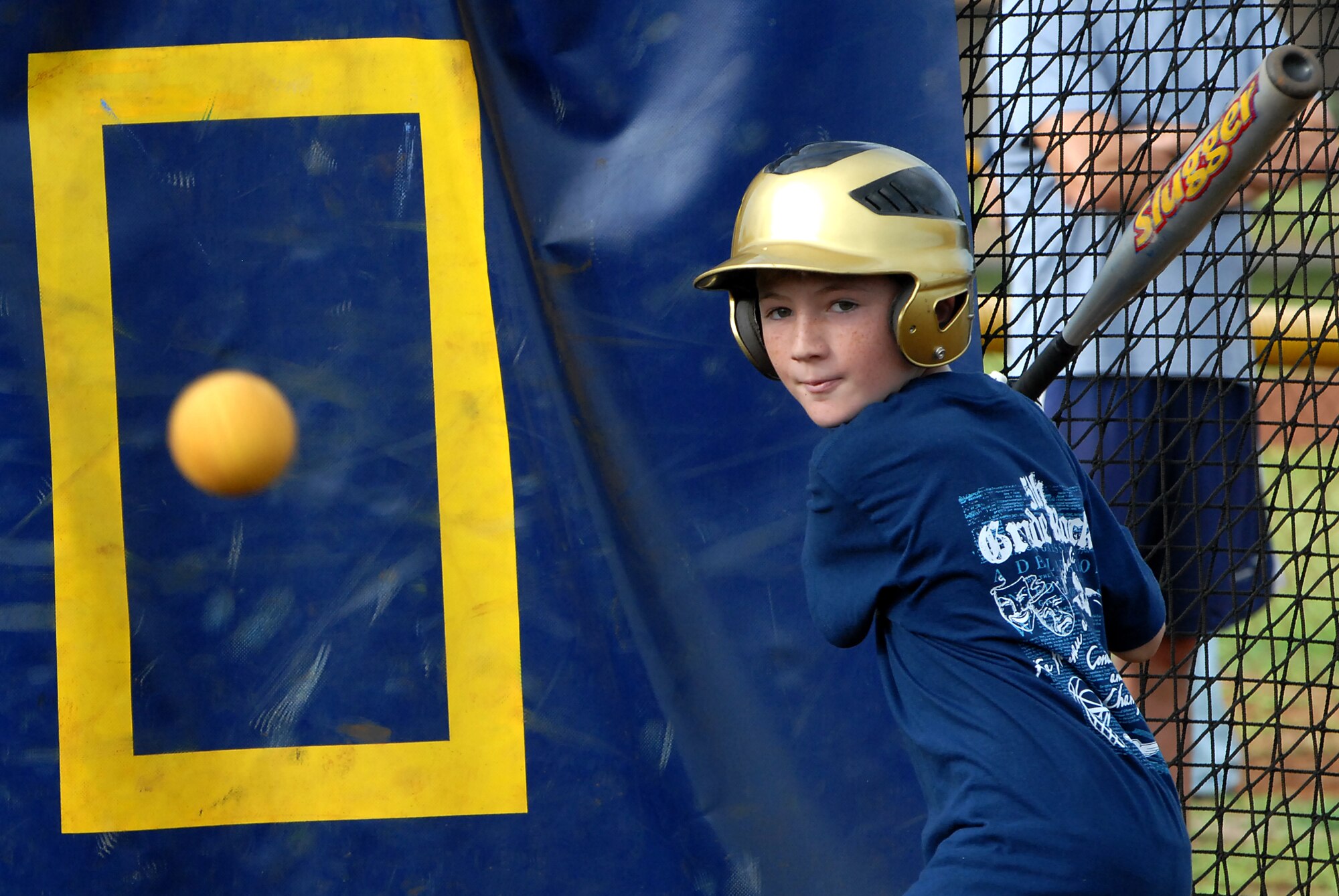 Josh Shewalter, 11, takes aim at a pitch inside the batting cages during a baseball clinic Dec. 18 at Joint BAse Pearl Harbor-Hickam. Hickam and Pearl Harbor children were taught baseball fundamentals by University of Hawaii and Hawaii Pacific University coaches and players duringthe event. The baseball clinic is the first of an annually planned event for the Friends of Hickam. (U.S. Air Force photo/Staff Sgt. Mike Meares)