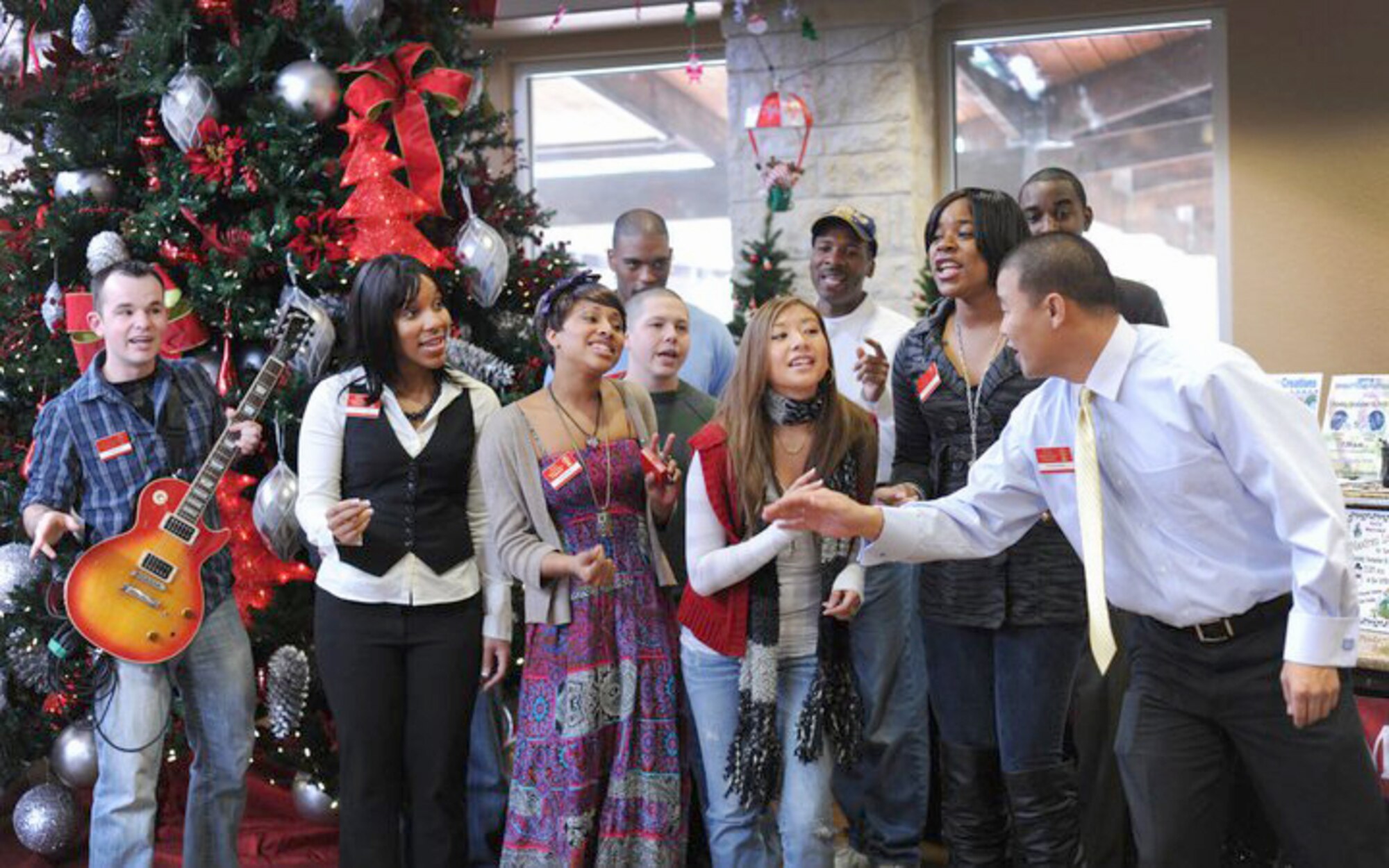 Contestants for the 2011 Tops in Blue worldwide team sing holiday songs for servicemembers and their families Dec. 11, 2010, at the Fort Sam Houston Warrior Center in San Antonio, Texas. The Warrior Center provides meals, shelter, education, and various programs for wounded warriors have been injured in battle. The Tops in Blue team has developed the Give Back program that allows annual contestants to sing holiday songs for servicemembers to provide encouragement and morale support. (U.S. Air Force photo/Staff Sgt. Vernon Young)