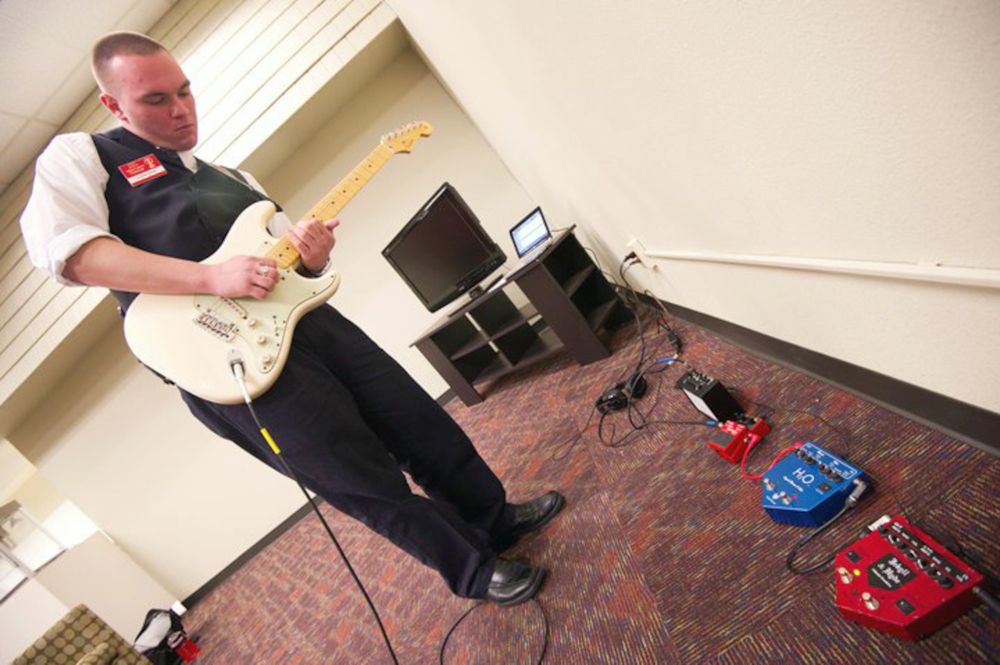 Airman 1st Class Jeffrey Cleghorn practices his guitar solo Dec. 7, 2010, before his audition with the 2011 Tops in Blue Team at Lackland Air Force Base, Texas. Tops in Blue held auditions for Airmen interested in being part of the 2011 Team. (U.S. Air Force photo/Staff Sergeant Matt Davis) 