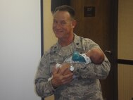 Lt. Col. Charles Combs, 916th Maintenance Group commander, shows his softer side during the wing's holiday luncheon. (USAF photo by Capt. Jarius Wallace, 916MXG)                     