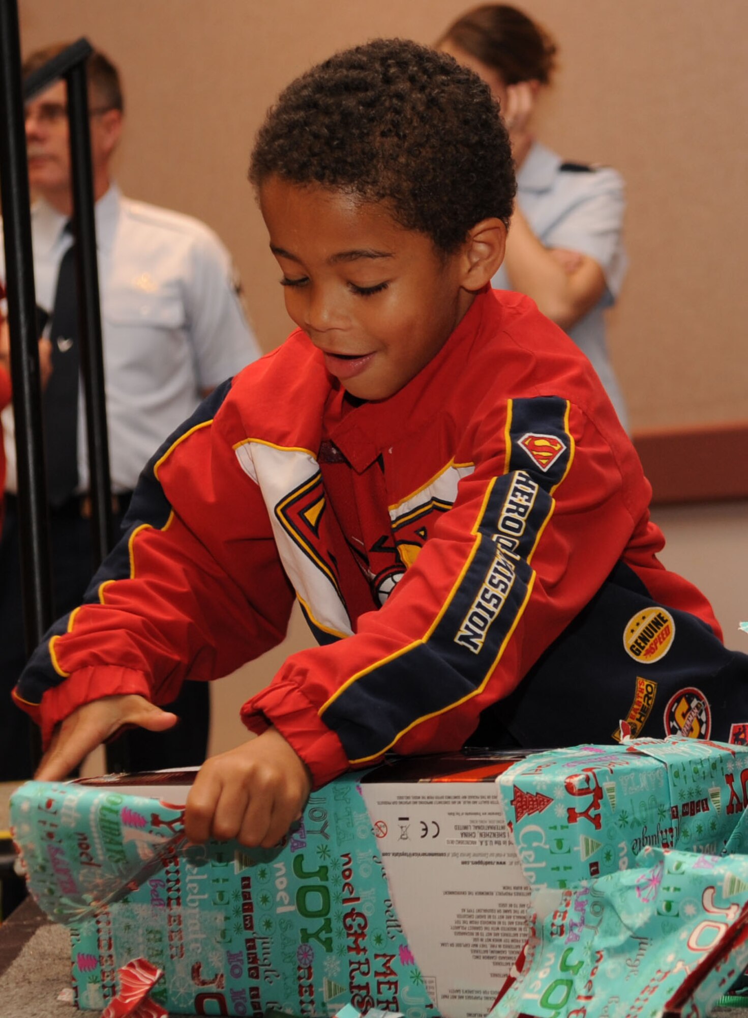 Jacob Thrasher, 6, opens gifts during the Santa?s in Blue event at the Bossier City Civic Center in Bossier City, La., Dec. 18. Santa?s in Blue is a program sponsored by the Air Force Sergeants Association and Barksdale Top Three to provide gifts for more than 400 children in foster care. (U.S. Air Force photo/Airman 1st Class Sean Martin)(Released)