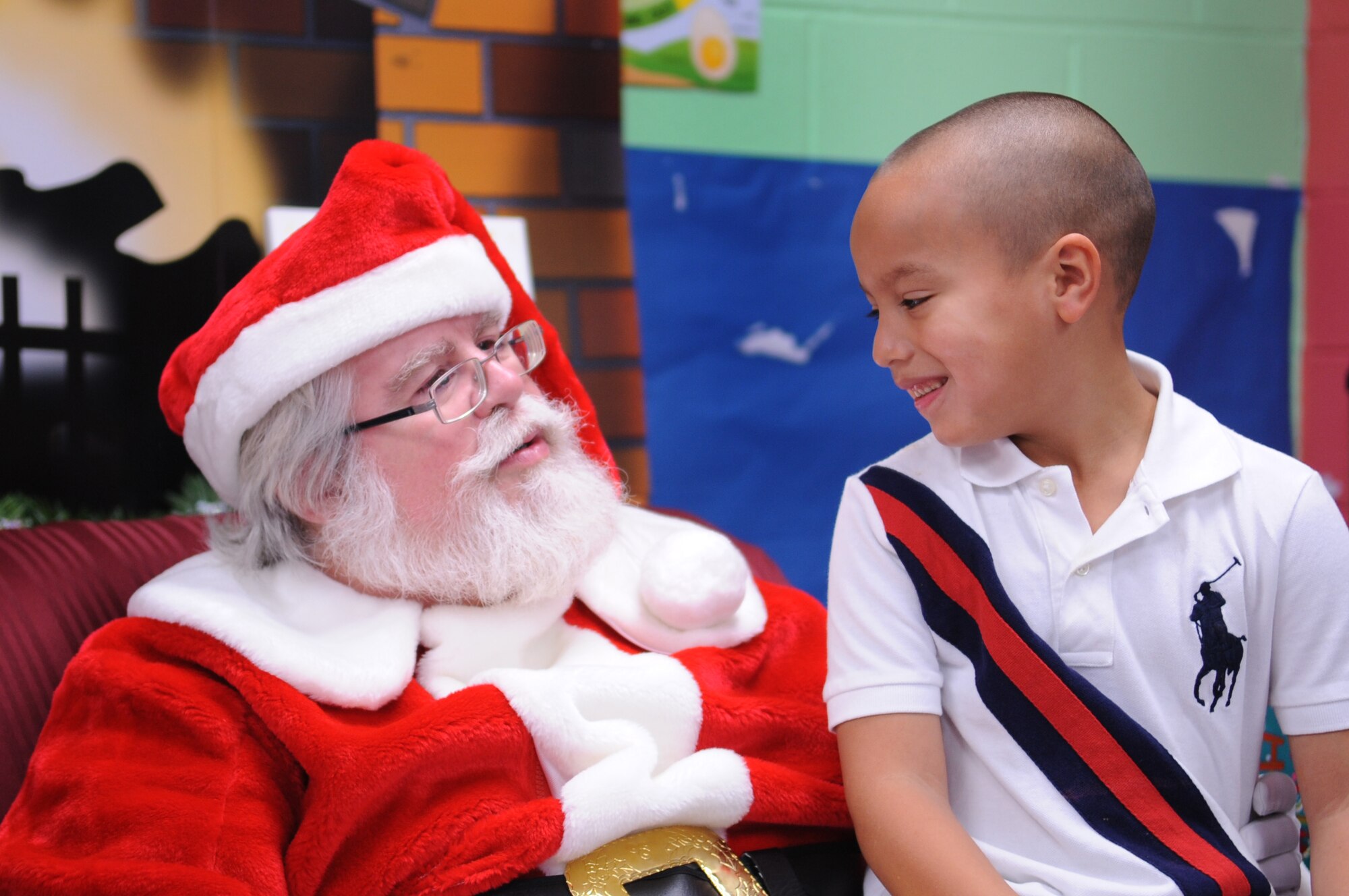 MOODY AIR FORCE BASE, Ga. -- Dyami Carneg talks with Santa Claus during the Breakfast with Santa event at the Youth Center Dec. 18. Dyami told Santa all of his Christmas wishes and what he hopes to receive on Christmas. (U.S. Air Force photo/Airman 1st Class Douglas Ellis)(RELEASED)
