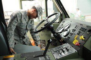 SOTO CANO AIR BASE, Honduras - Staff Sgt. Josue Santiago inspects the inside of a Heavy Expanded Mobility Tactical Truck-M978 A3. Petroleum, Oil and Lubricant shop troops here trained on the new capabilities and functions of their 9 newest fleet additions Dec. 13. (U.S. Air Force photo/Staff Sgt. Kimberly Moore)