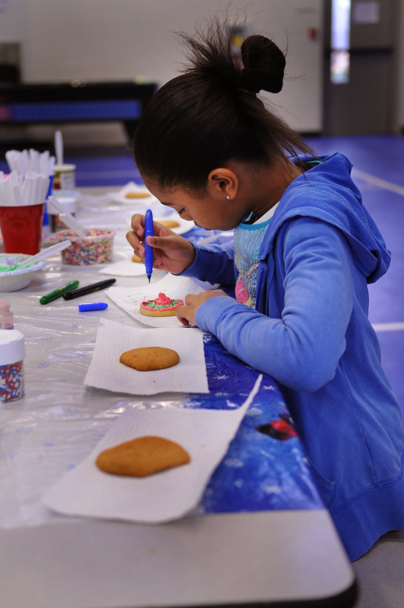 MOODY AIR FORCE BASE, Ga. -- JaDari Ussery creates a design on a cookie during the Breakfast with Santa event at the Youth Center Dec. 18. During the event, children decorated cookies and snowflakes while they waited for Santa Claus. (U.S. Air Force photo/Airman 1st Class Douglas Ellis)(RELEASED)