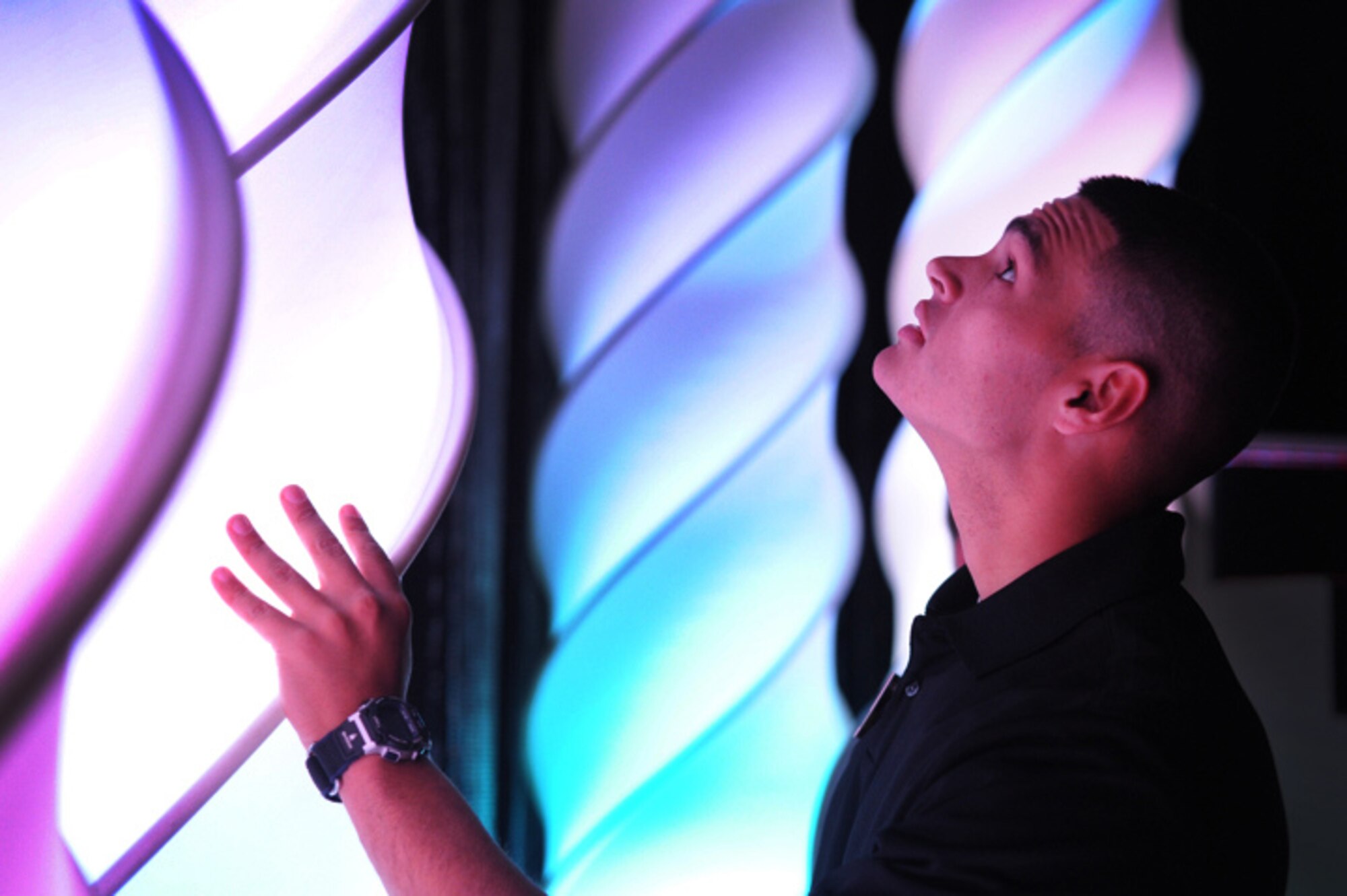 JOINT BASE SAN ANTONIO, Texas -- Senior Airman Jamie Ramirez, a ground radio journeyman from Beale Air Force Base, Calif., adjusts the stage lighting before the vocal auditions portion of the 2011 Tops in Blue worldwide auditions held at the Bob Hope Performing Arts Center, Lackland Air Force Base, Texas, Dec. 9, 2010. Airman Ramirez was responsible for aligning the 50-foot lighting fixtures on the stage in preparation for the final show. Technical team contestants are responsible for stage crew, lighting, and audio equipment during the 10-day audition. Airman Ramirez was named best technician for the competition. (U.S. Air Force photo/Staff Sgt. Vernon Young)