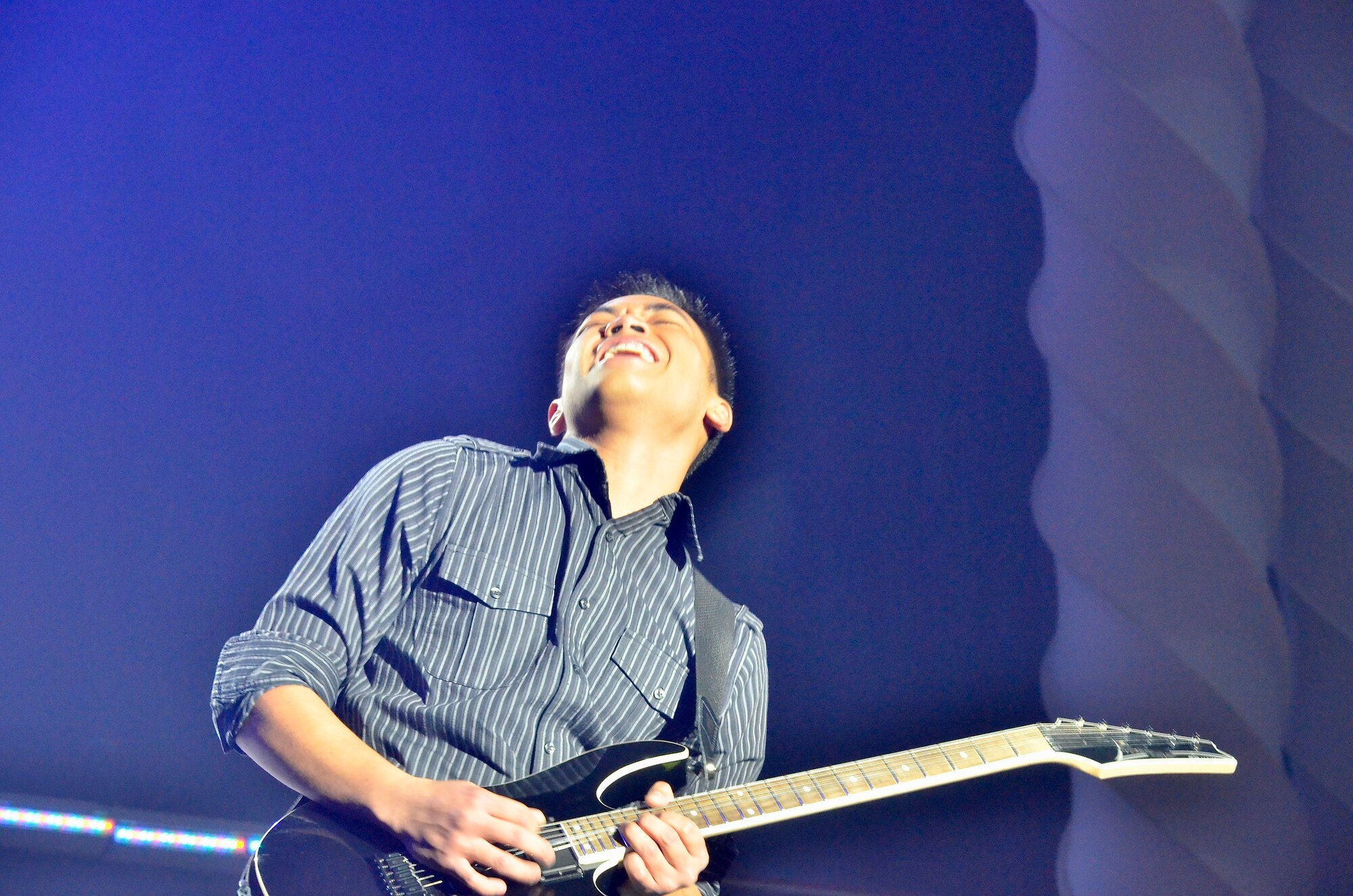 Airman 1st Class Jonathan Salvador from Minot Air Force Base, N.D., gives it his all during his electric guitar solo at the Bob Hope Performing Arts Center, Lackland AFB, Texas, during the Tops in Blue Worldwide Talent Search on December 10, 2010. Airman Salvador was named best in show and top musician for the competition that allows Airmen to audition for spots on the Tops In Blue team. (Courtesy Photo)

