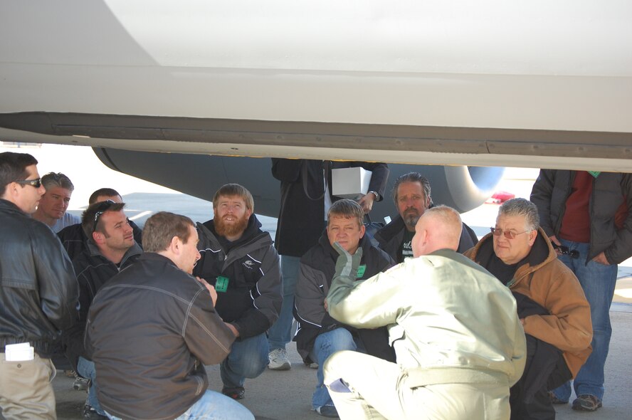 Tech. Sgt. Steve Stanton, 77th Air Refueling Squadron boom operator, explains how the KC-135R works to members of the Michael Waltrip Racing Team. More than 50 NASCAR team members flew with the Seymour Johnson wing on Dec. 17. (USAF courtesy photo)