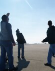 Members of Michael Waltrip Racing look to the skies to see the F-15 demo team practice. More than 50 members of the NASCAR team flew with the 916th ARW on Dec. 17. (USAF photo by MSgt. Wendy Lopedote, 916ARW/PA)