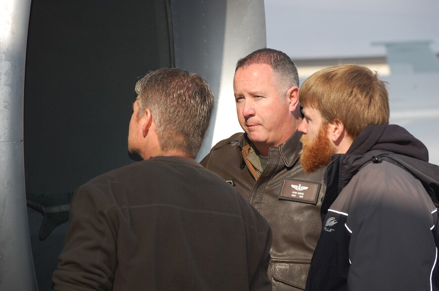 Master Sgt. Kevin Hughes (center), boom operator with the 77th Air Refueling Squadron, talks to members of Michael Waltrip Racing during a recent flight aboard a KC-135R here. 