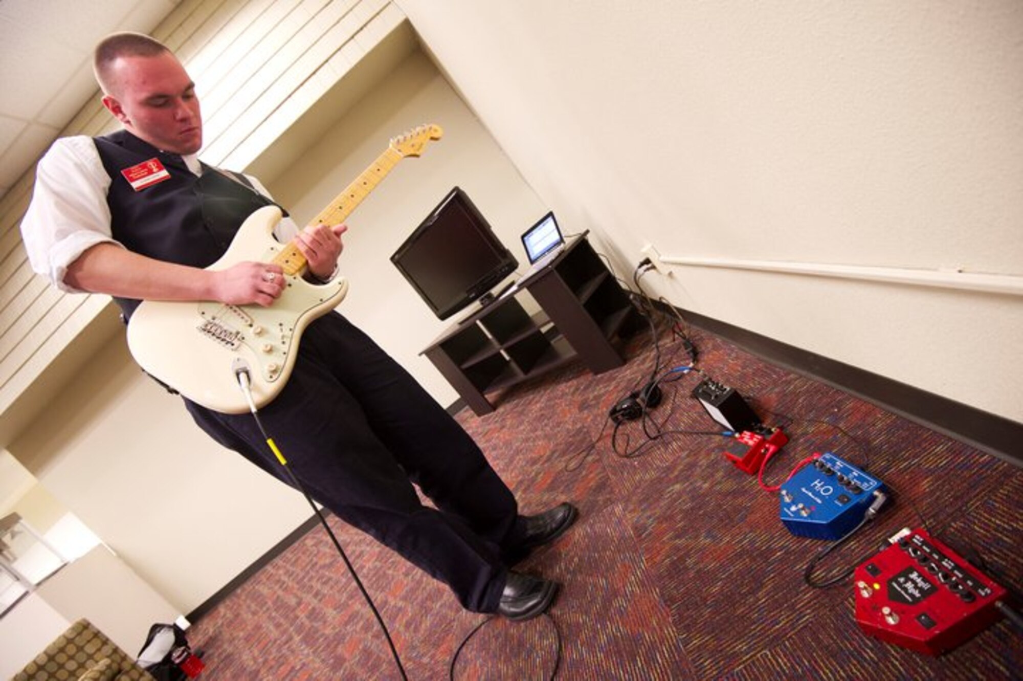 JOINT BASE SAN ANTONIO, Texas - Airman 1st Class Jeffrey Cleghorn practices his guitar solo before his audition with the 2011 Tops in Blue Team held at the Bob Hope Performing Arts Center, Lackland AFB, Texas, Dec. 7,2010. Tops in Blue held auditions for Airmen interested in being part of the 2011 Team. (U.S. Air Force photo/Staff Sergeant Matt Davis)
