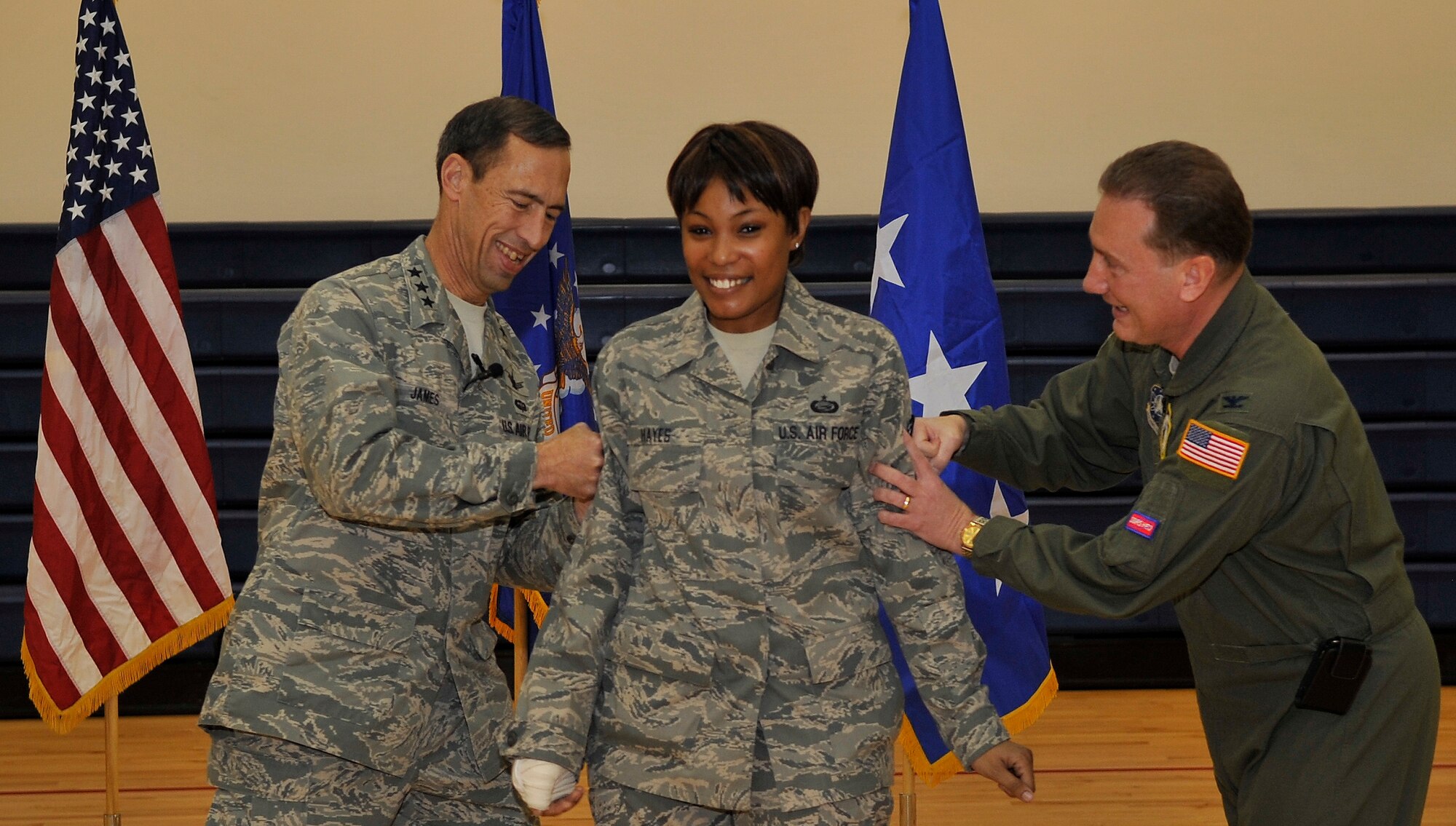 BUCKLEY AIR FORCE BASE, Colo. -- Recently promoted Tech. Sgt. Kandyse
Hayes , 460th Force Support Squadron is pinned on by Lt. Gen. Larry D. James,   14th Air Force Commander (Left) and Col. Clint Crosier, 460th Space Wing Commander (Right) on Dec. 16, 2010. (U.S. Air Force photo by Airman 1st Class Paul Labbe.)
