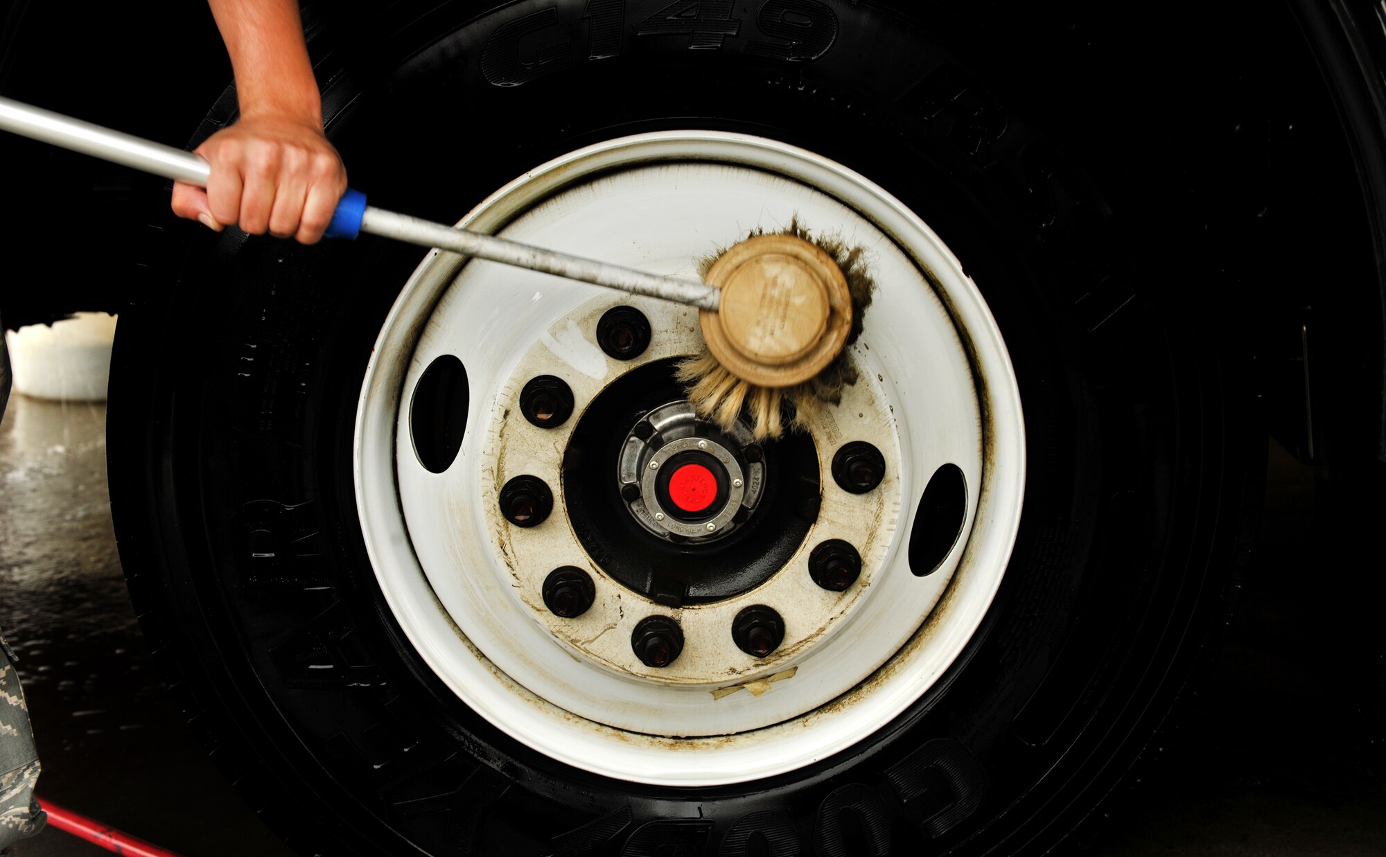 MOODY AIR FORCE BASE, Ga.-- A tire on a bus that was recently used in an operational readiness exercise is washed down and cleaned. On average, it takes between one to three hours to clean and inspect vehicles that come through the wash area. (U.S. Air Force photo/Airman 1st Class Joshua Green)(RELEASED)
